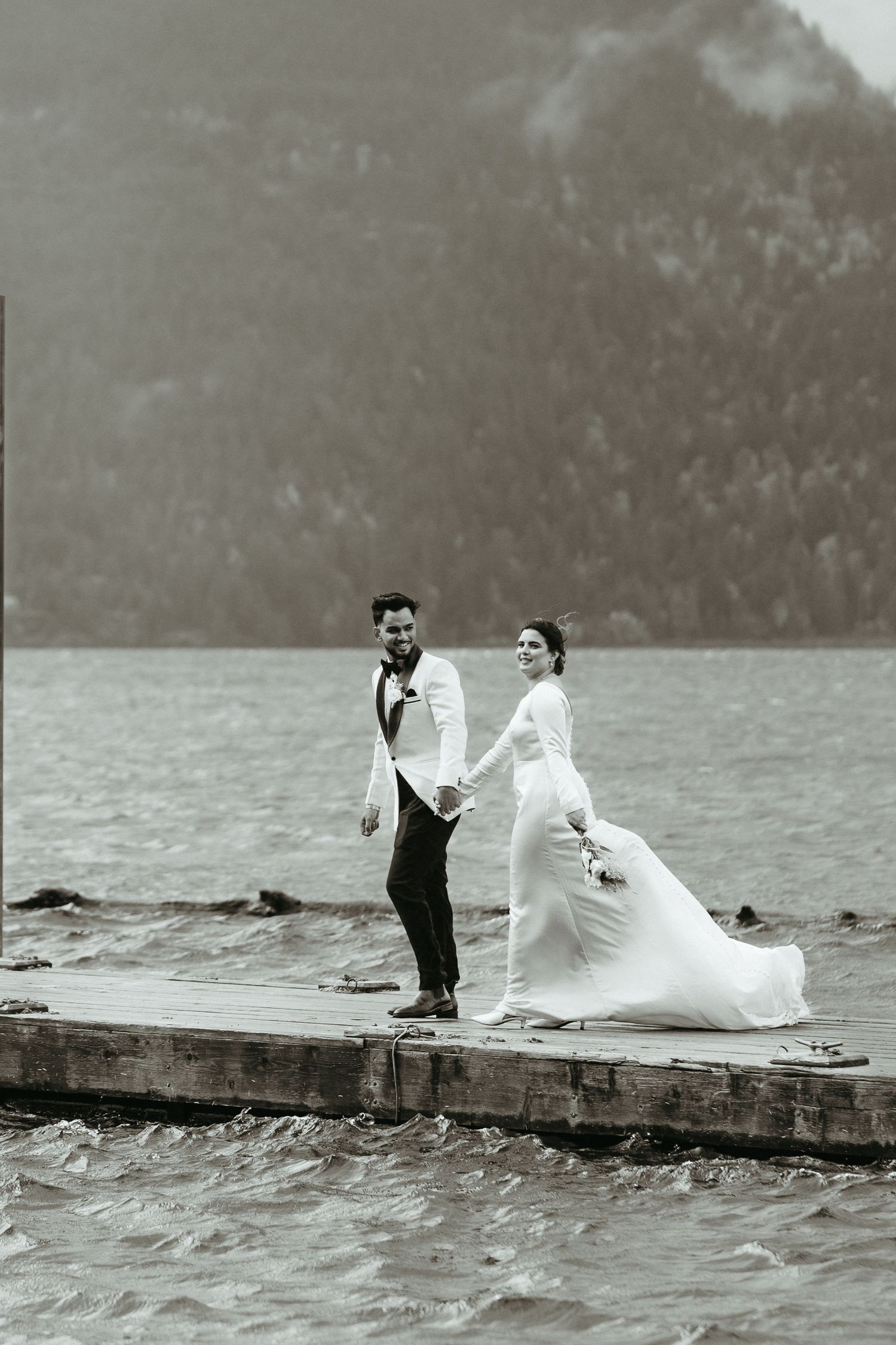 A sequence of wedding photos shows a couple playfully posing on a dock by a misty lake.