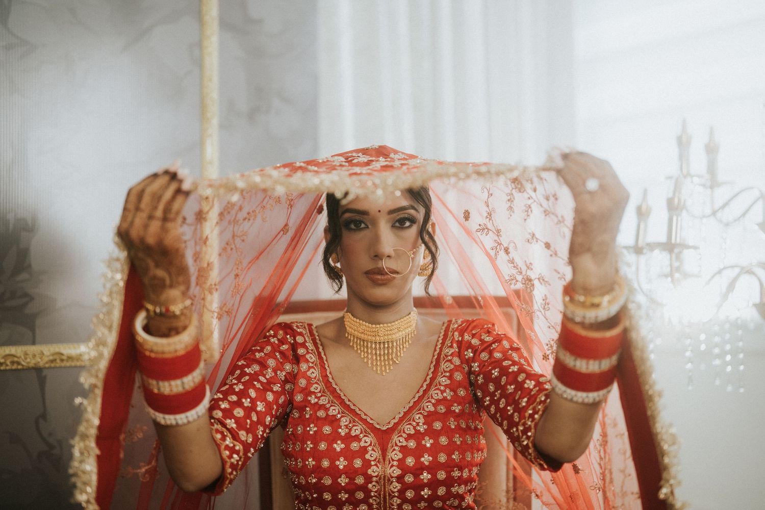 Elegant bridal portrait series featuring traditional red Indian wedding attire and jewelry.