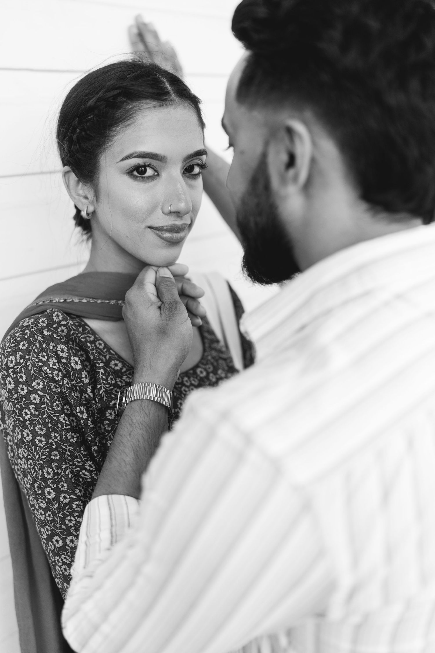 Black and white photo series showing intimate moments between two people in formal attire.