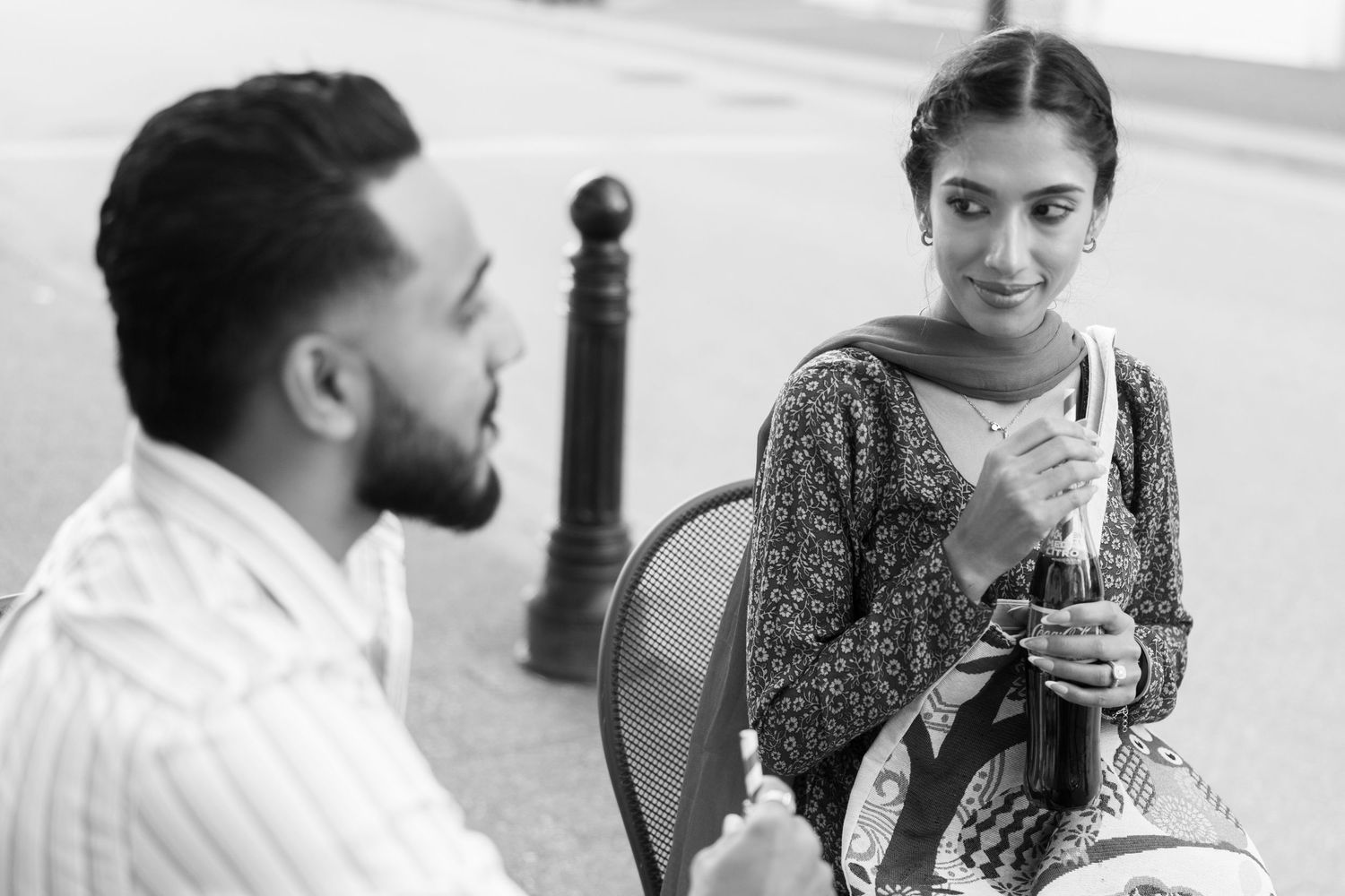 A black and white photo sequence shows a couple sharing coffee and intimate moments at a cafe table.
