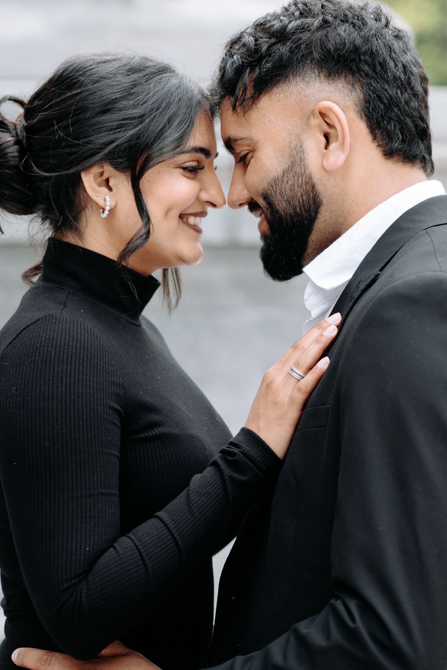 A series of intimate close-up shots showing a couple in black attire sharing tender moments.