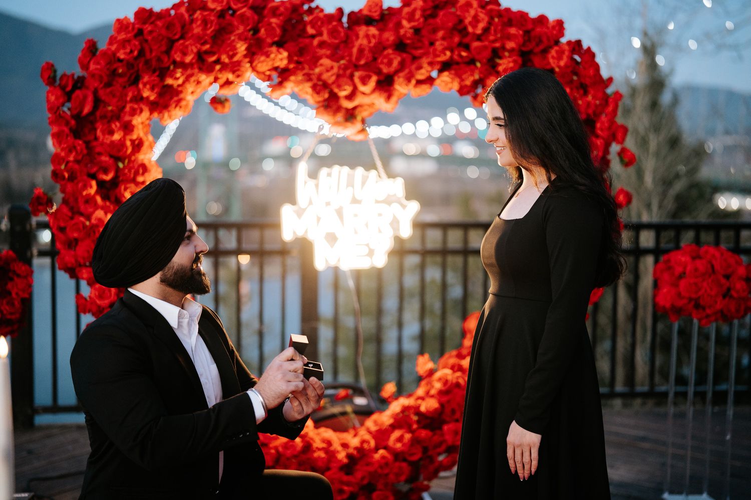 A romantic wedding photo series with silhouettes against a backdrop of vibrant red floral decorations and soft lighting.