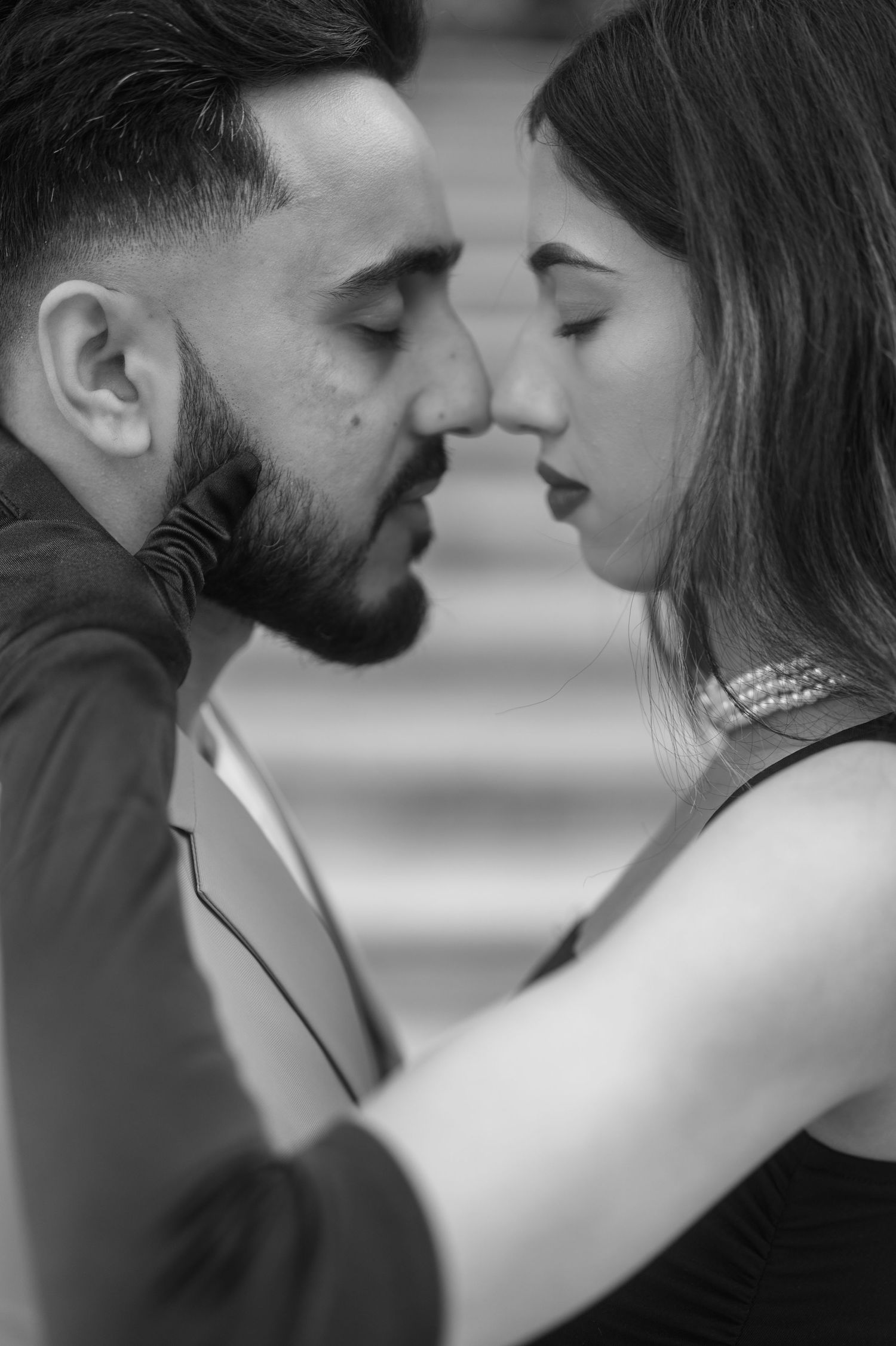 A romantic black and white photo series showing an intimate couple about to kiss in various close-up shots.
