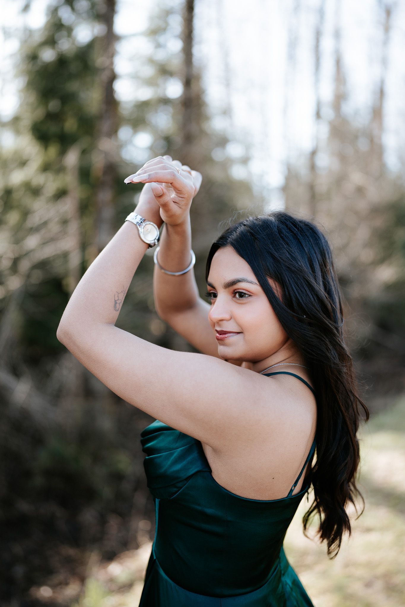 A person in a dark top poses outdoors with raised arms in a series of connected photos showing fluid movement.
