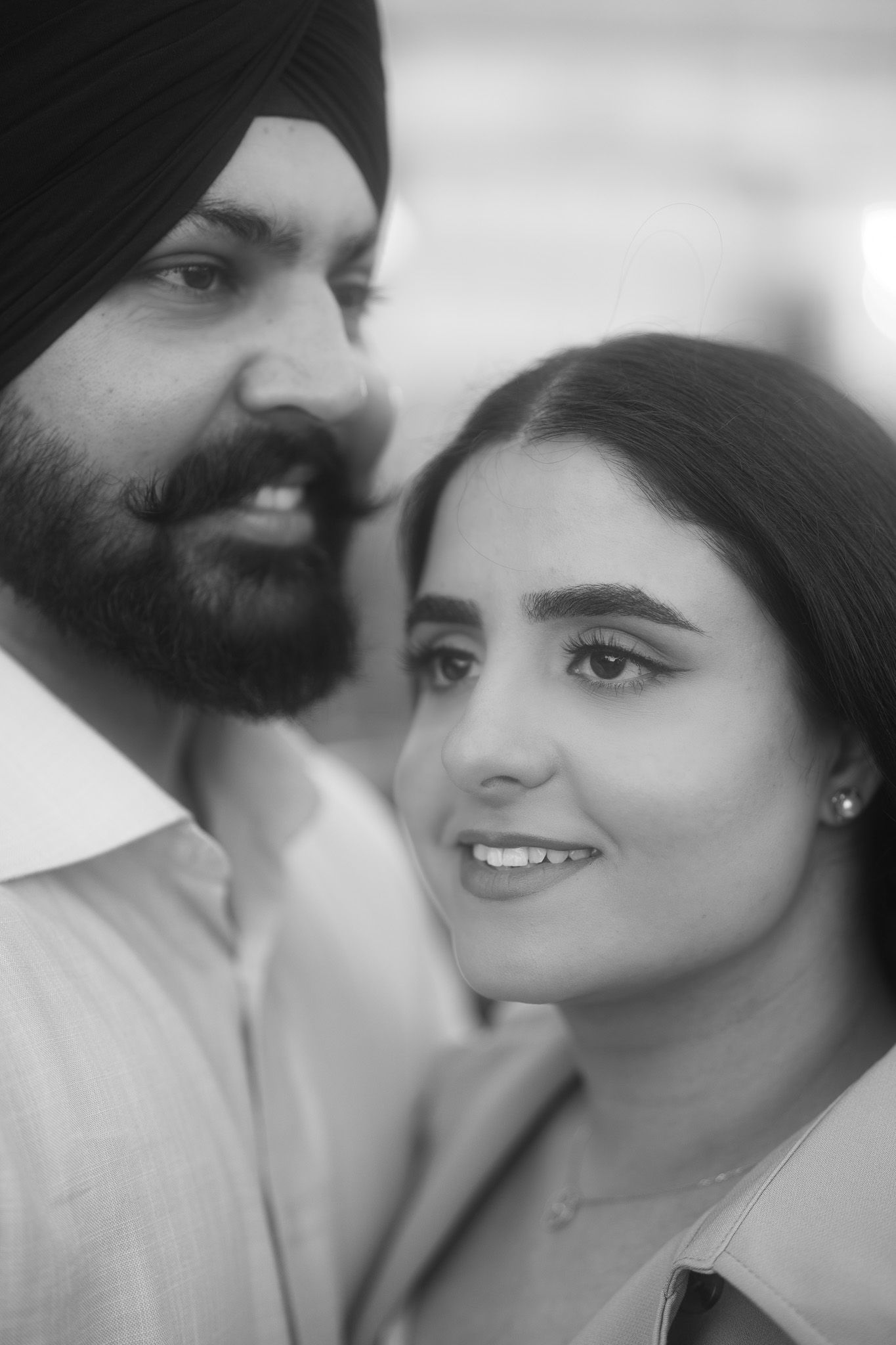 A romantic black and white photo series showing tender moments between a couple in close-up portraits.