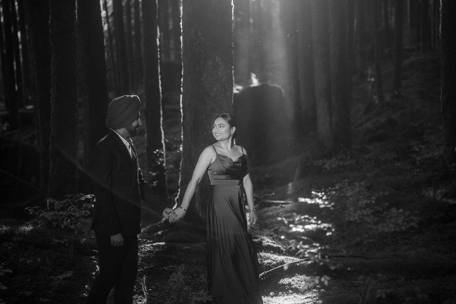 Moody forest photography with dramatic shadows and streaming sunlight.
