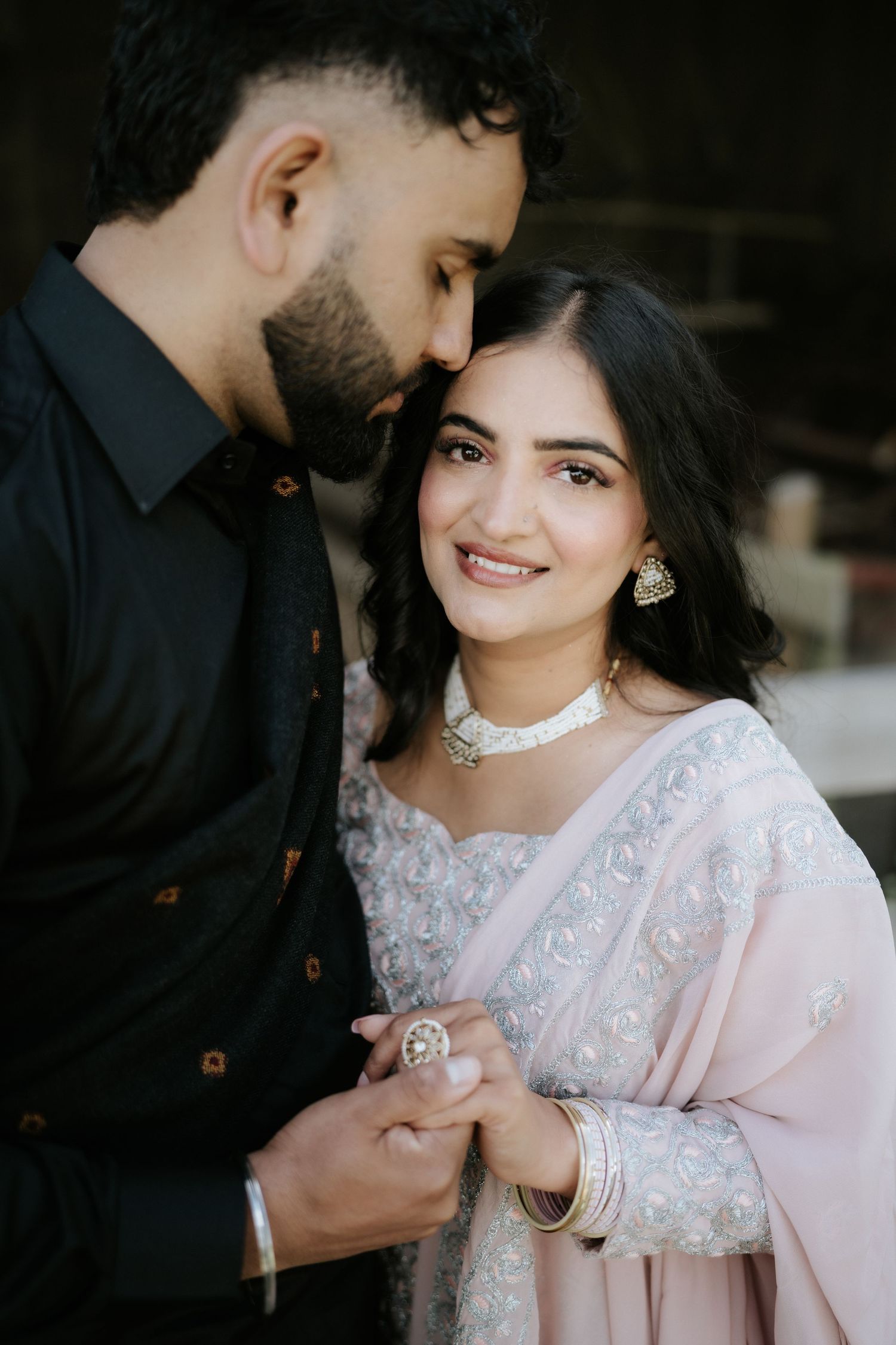 A romantic photoshoot featuring traditional South Asian attire and intimate poses.