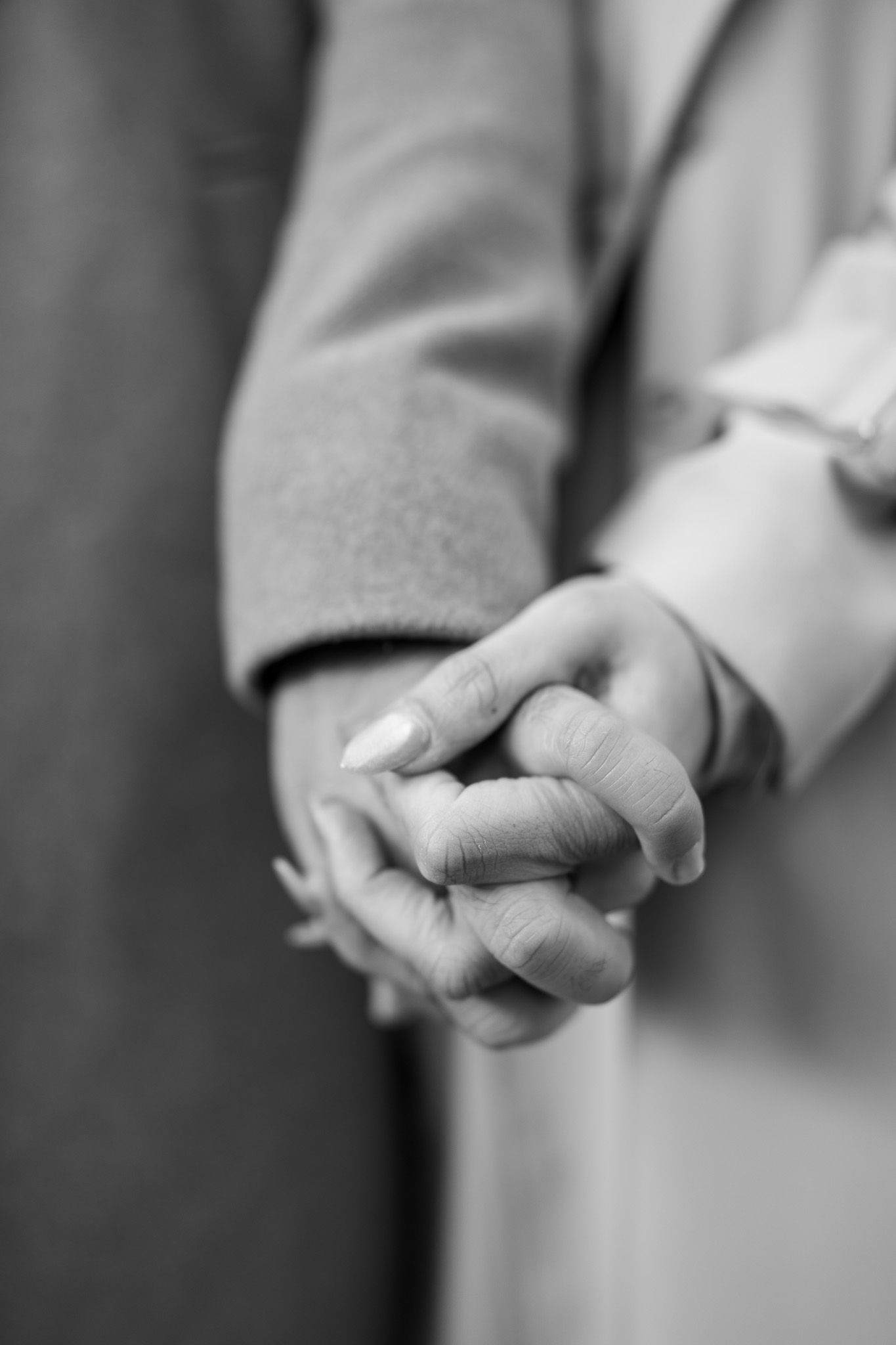 A series of black and white close-up photographs showing hands in different positions and gestures.