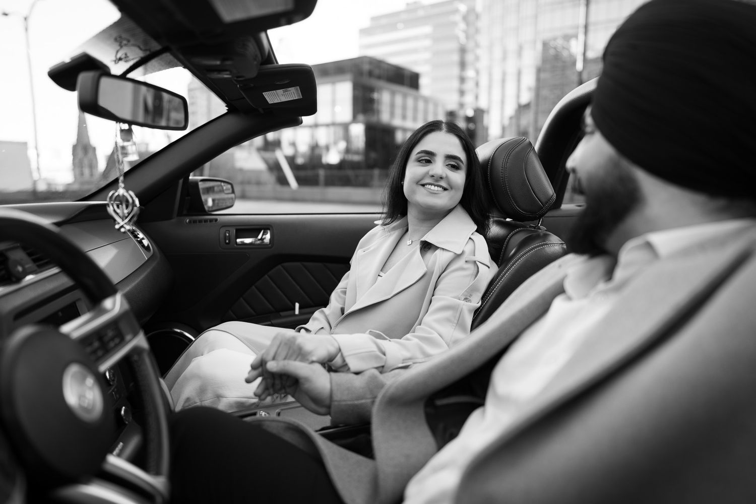 Black and white photo sequence showing someone driving a car while smiling and gesturing expressively.
