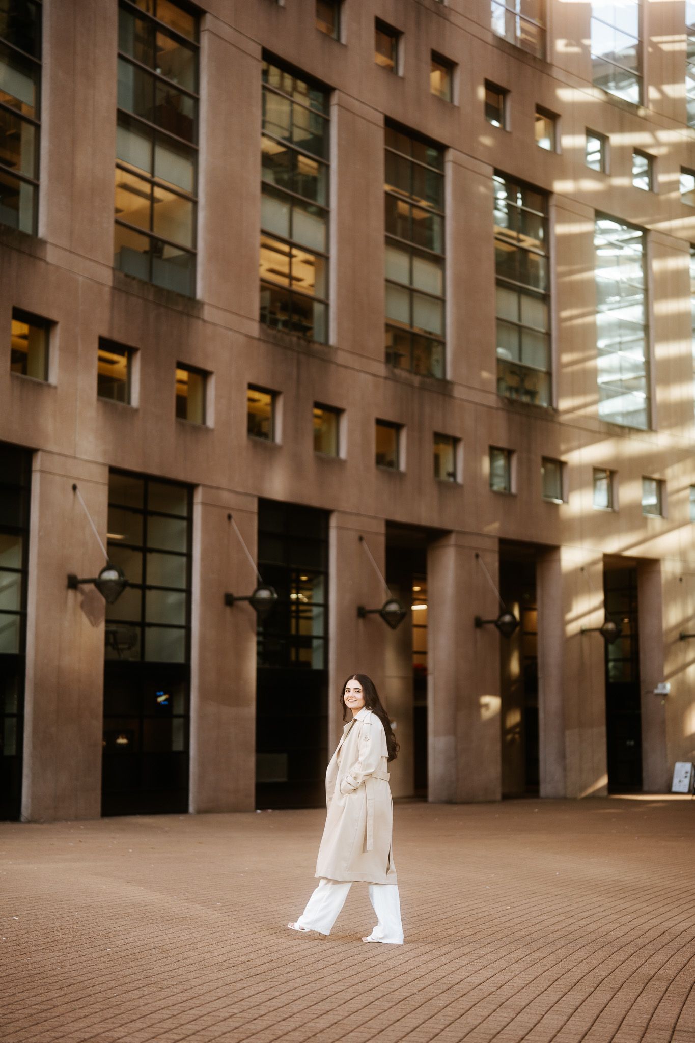 A minimalist architectural photo series featuring a person in white against a modern building facade.