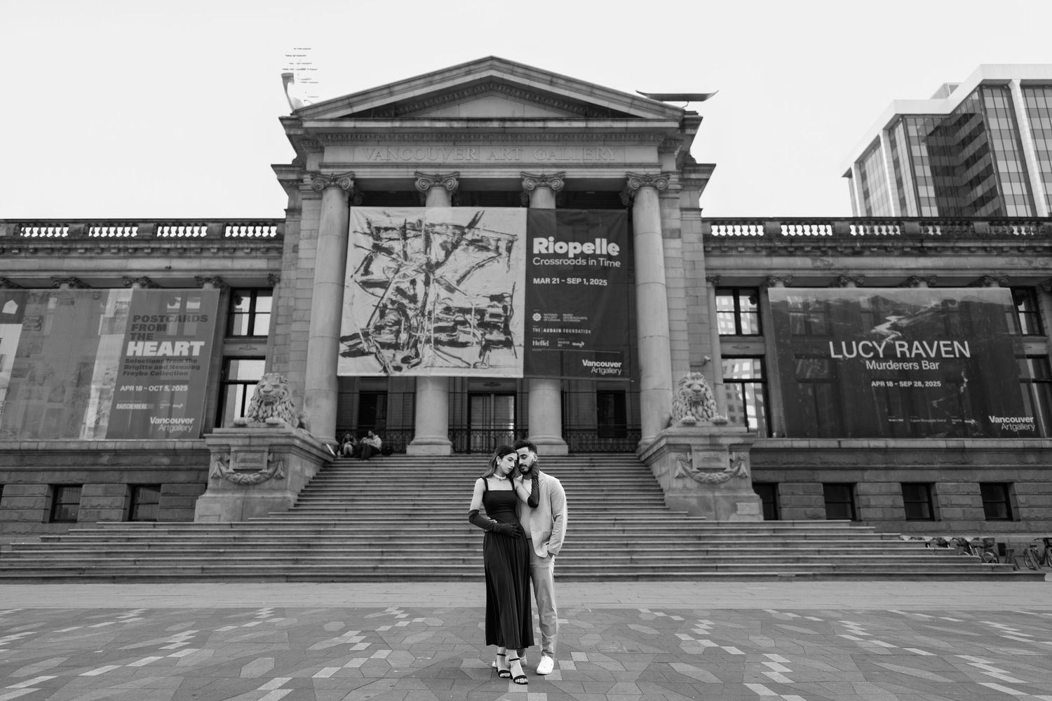 Exterior view of a classical architecture building with columns and signage at dusk.