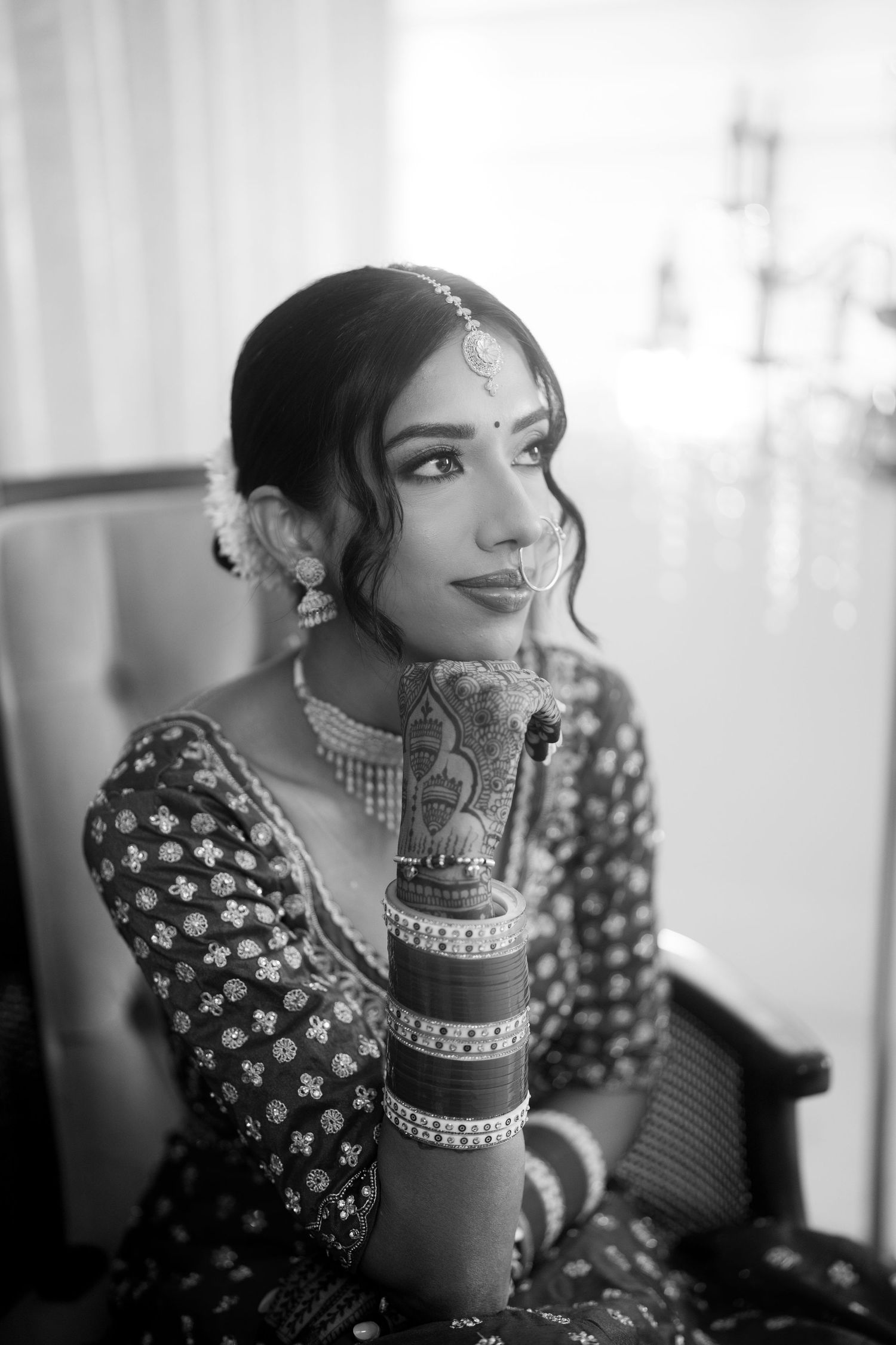 Black and white portraits capturing elegant bridal poses with traditional Indian jewelry and makeup.