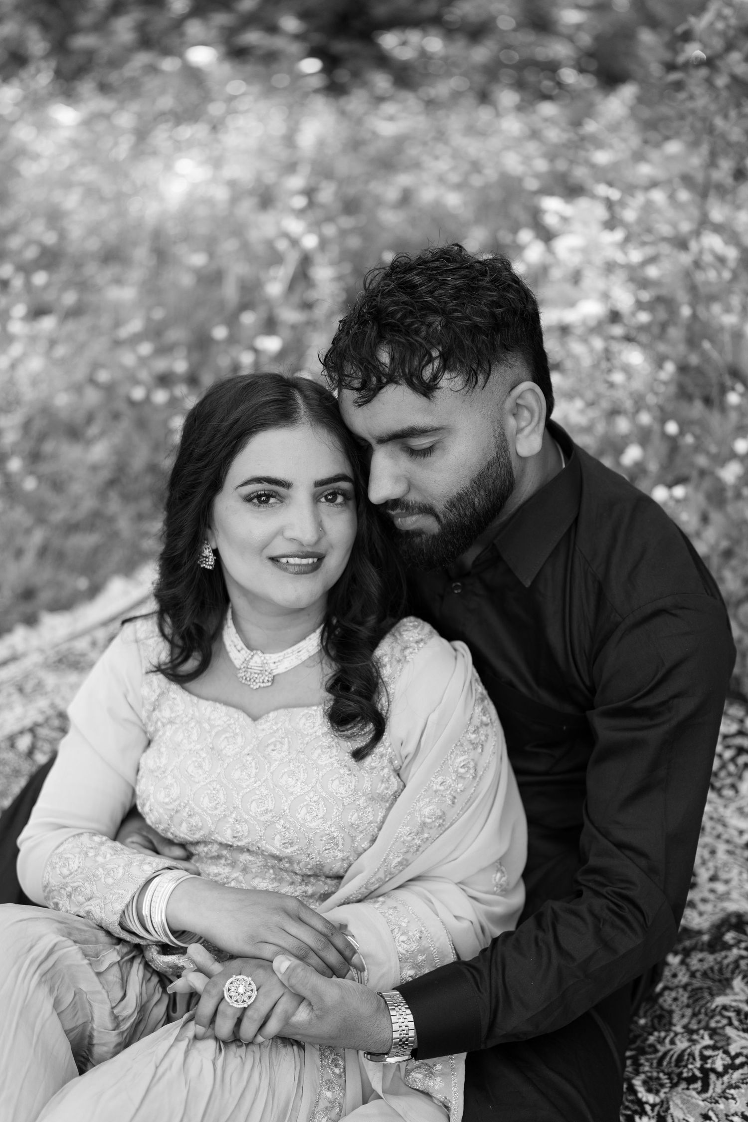 Black and white outdoor portrait series showing intimate couple moments on grass.