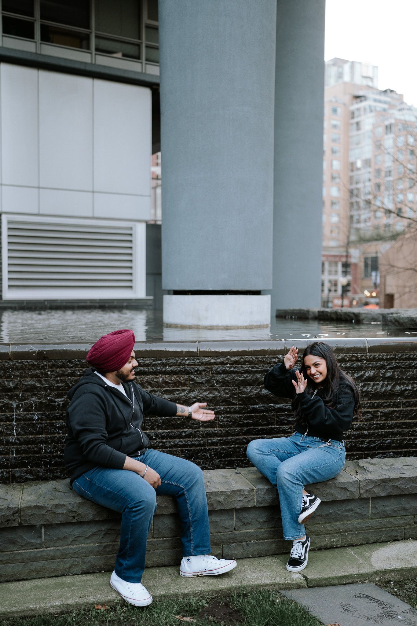 A sequence of candid moments showing two people sitting and interacting on stone steps outside a building.