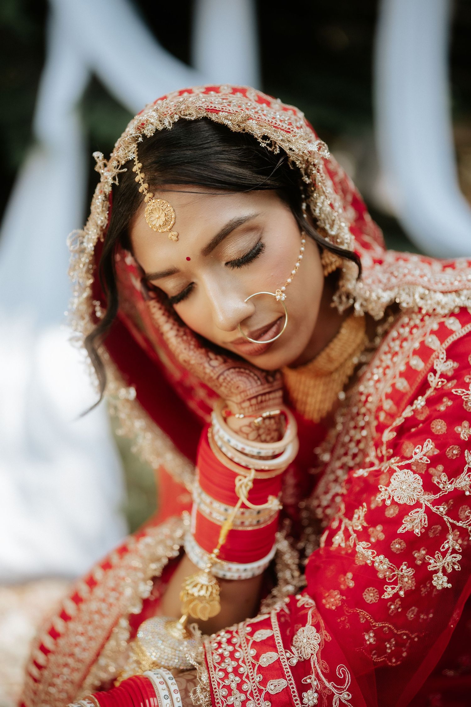 Close-up shots of traditional Indian bridal jewelry and red embroidered wedding attire.