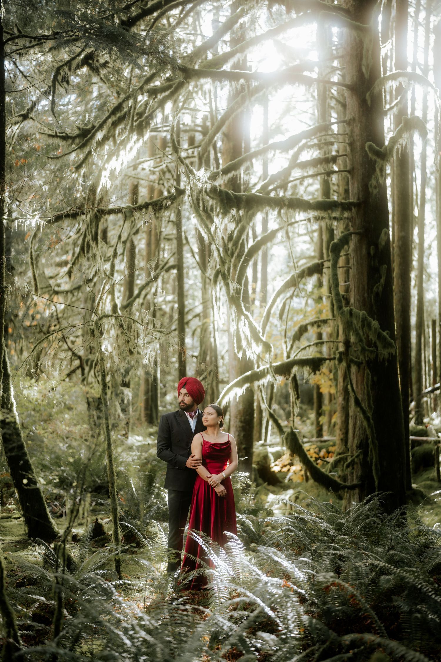 A romantic scene unfolds in a misty forest with red accents and ethereal lighting.