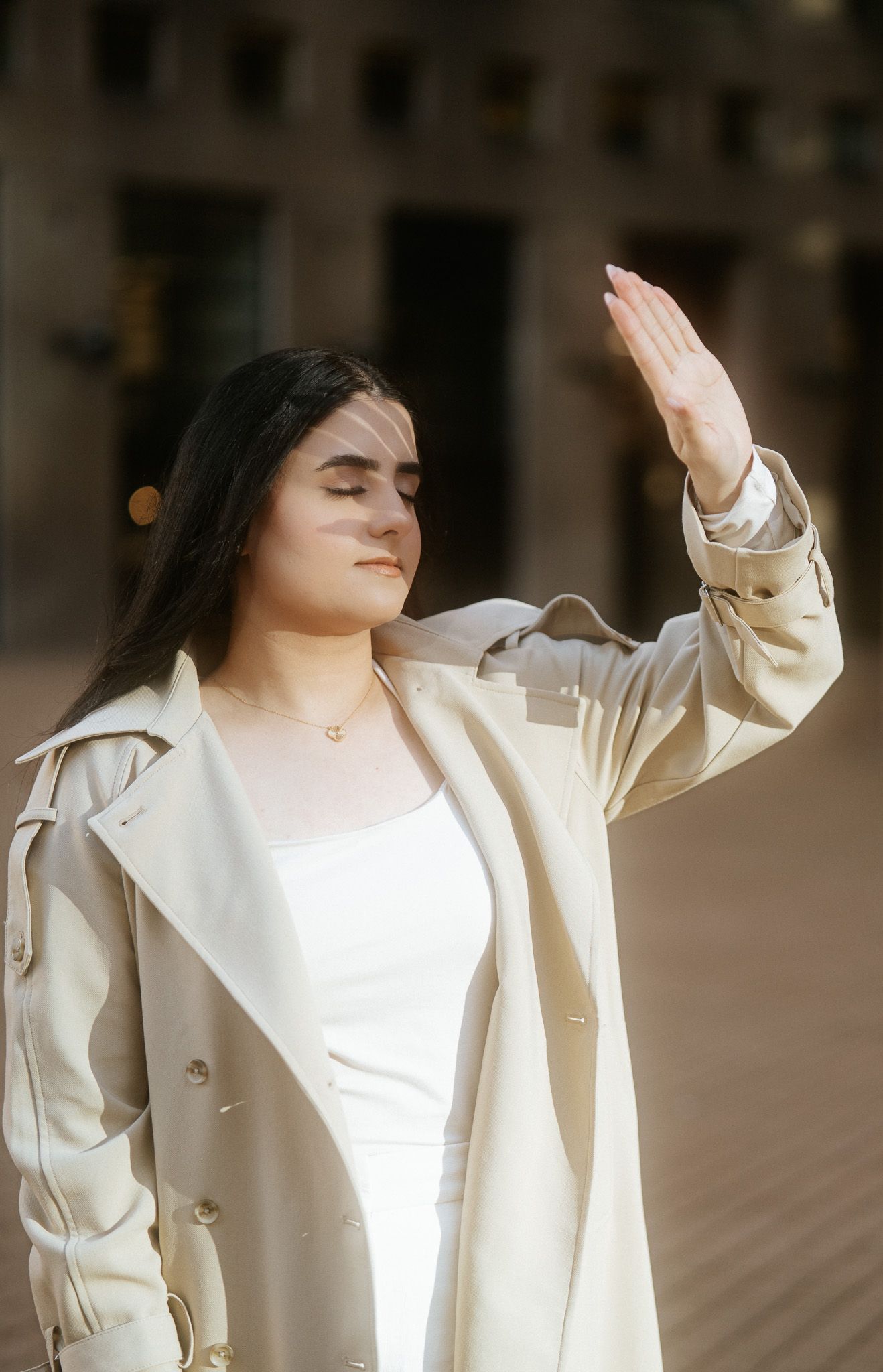 A woman in an elegant white blazer poses confidently in a series of connected fashion photographs.