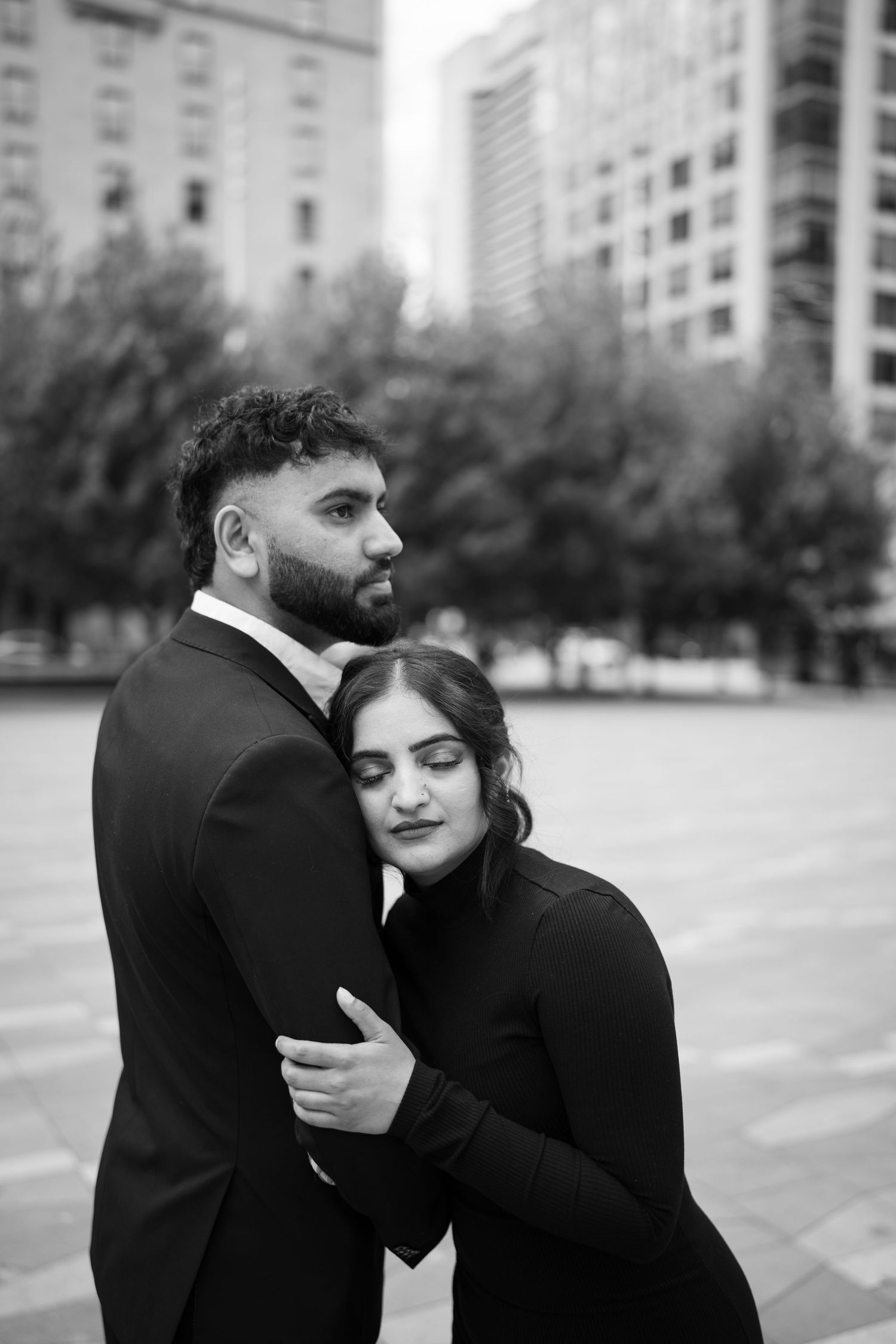 A romantic black and white photo series showing a couple embracing in an urban setting.