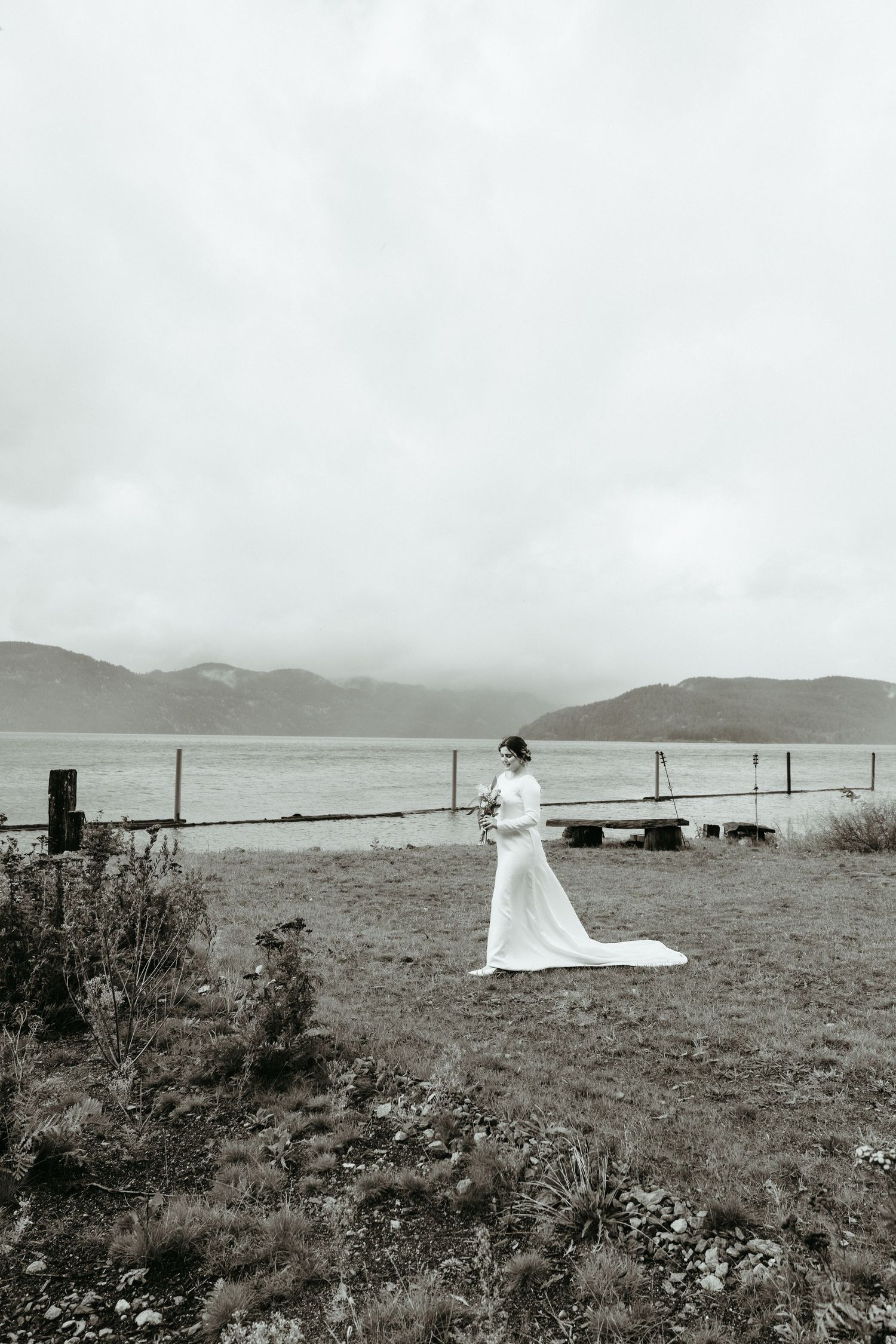 A series of vintage black and white photographs showing a figure in a white dress standing on a misty coastal landscape.