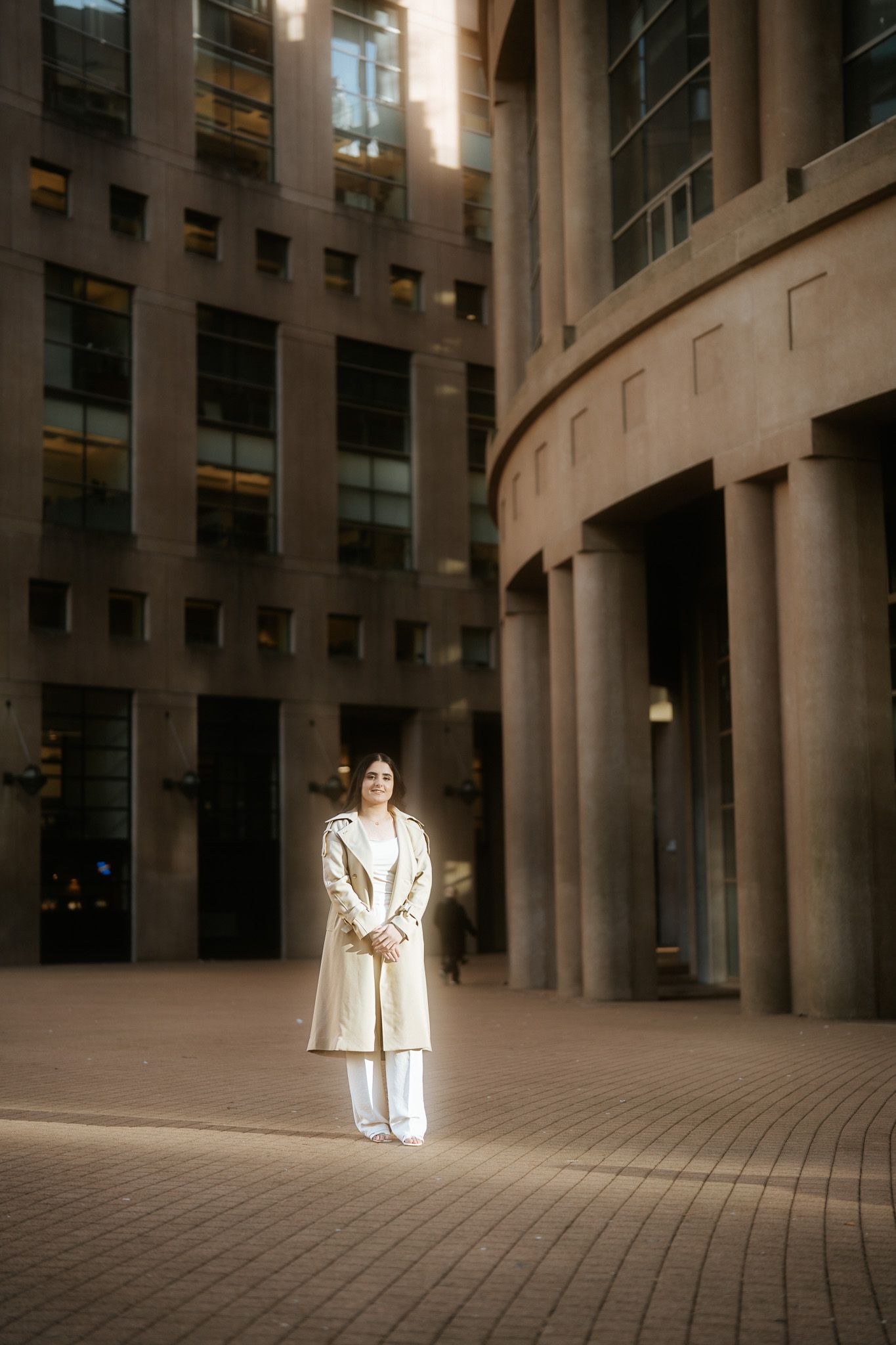 A sequence of photos showing a person in white clothing walking through a dimly lit curved architectural space.
