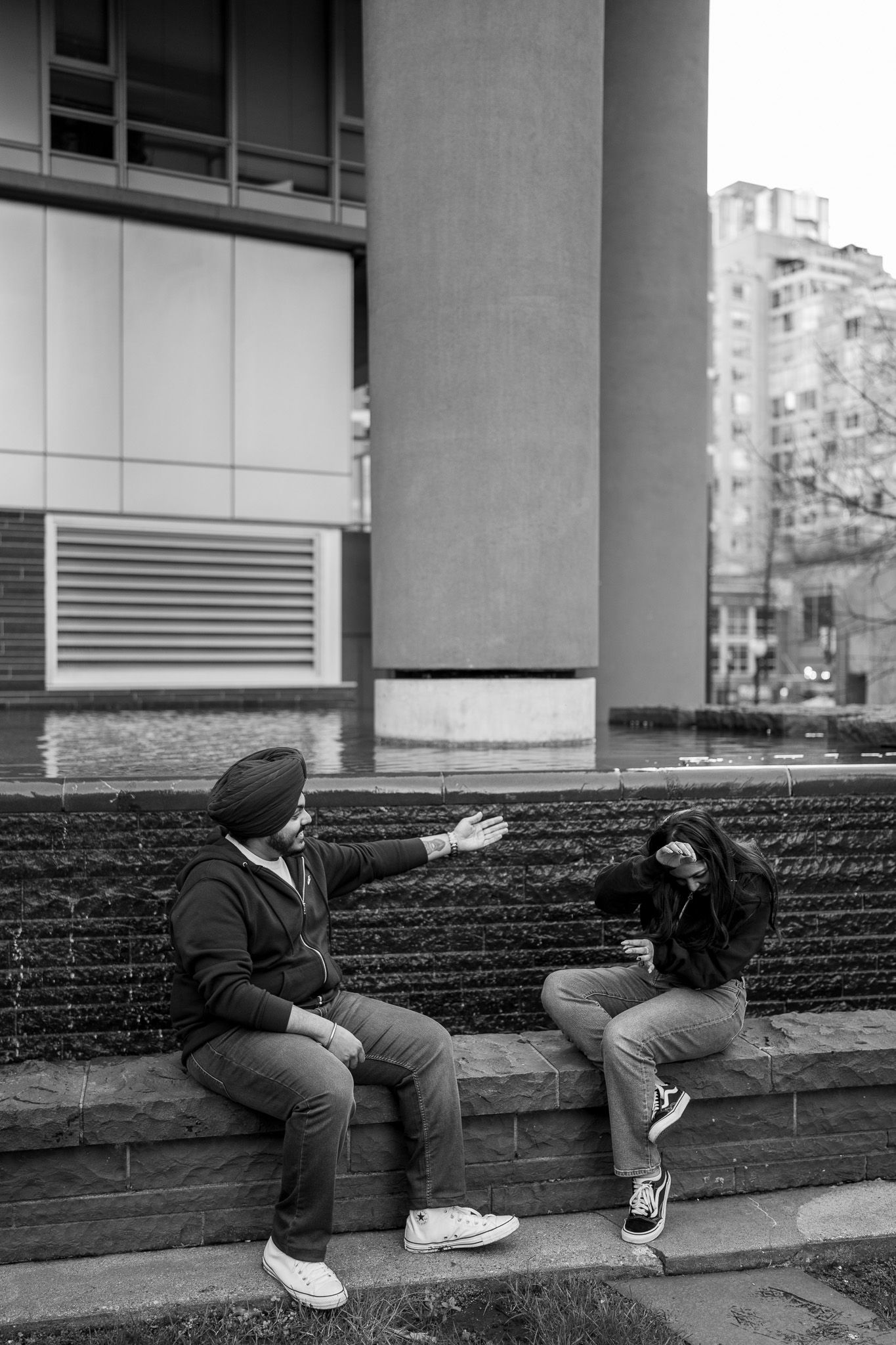 Black and white photo series showing person in casual wear reclining across stone steps in urban setting.