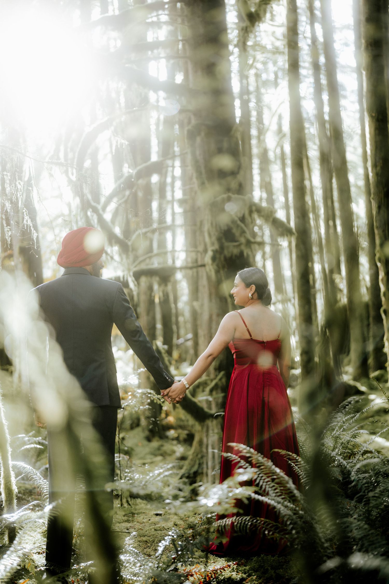 Ethereal forest scene with figures among misty trees and ferns.