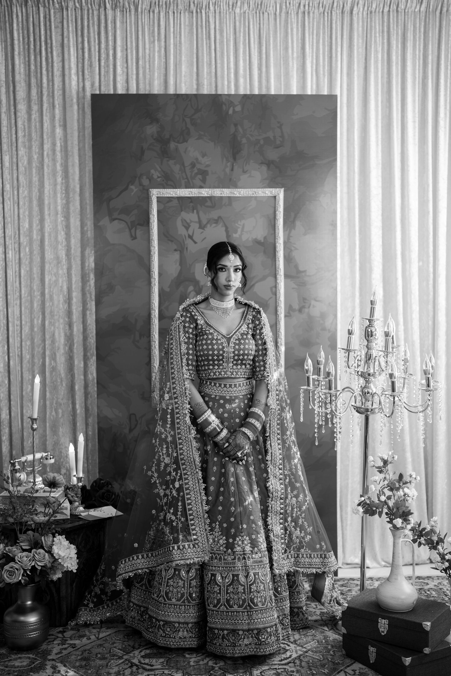 Artistic black and white portraits showcasing a traditional bridal lehenga in studio setting.
