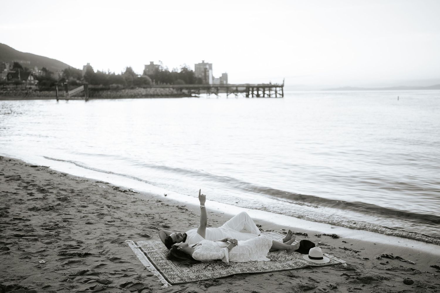 A series of black and white coastal photographs showing a beach landscape with waves, sand, and distant shoreline views.