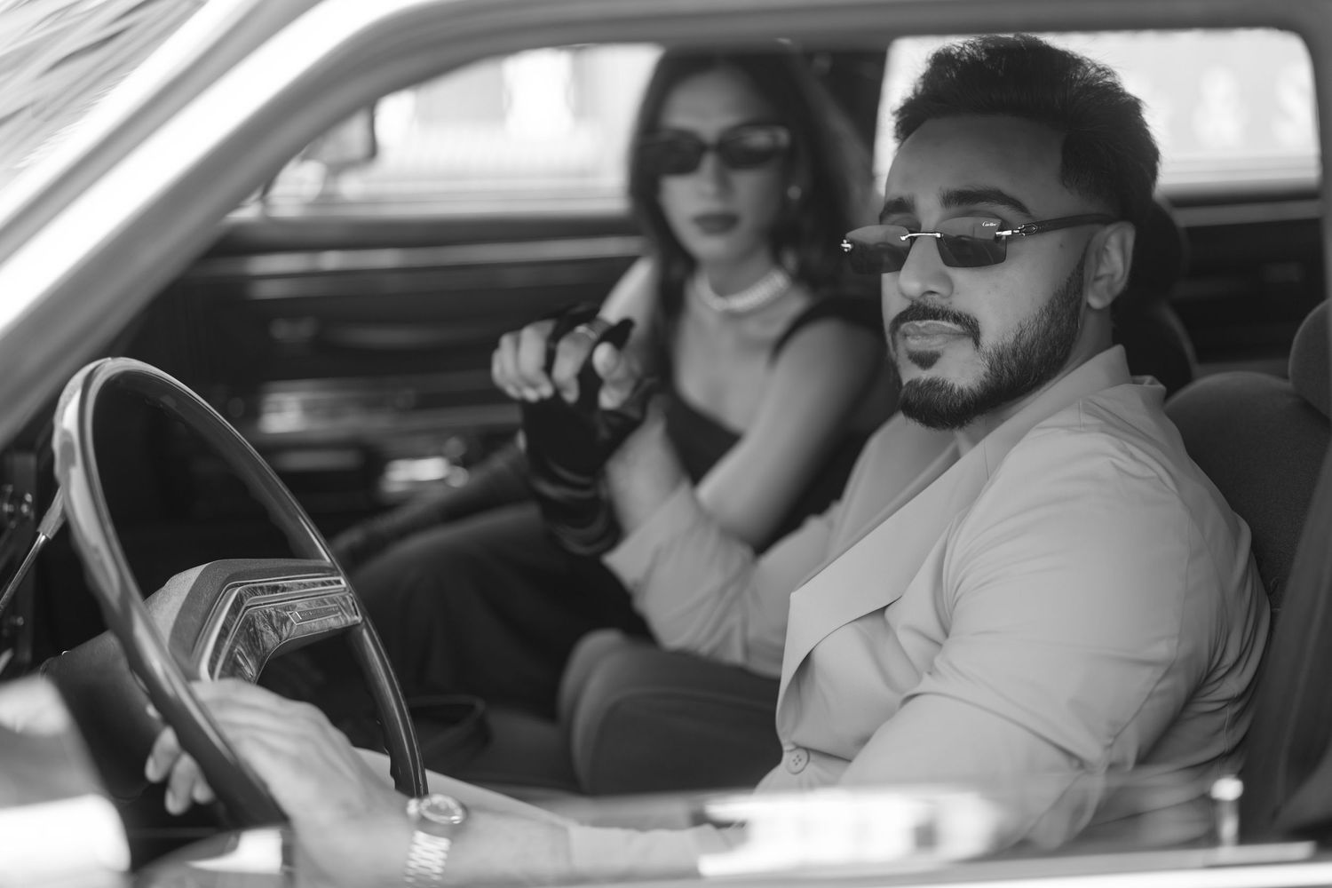 A black and white collage of people sitting in cars and looking through car windows.