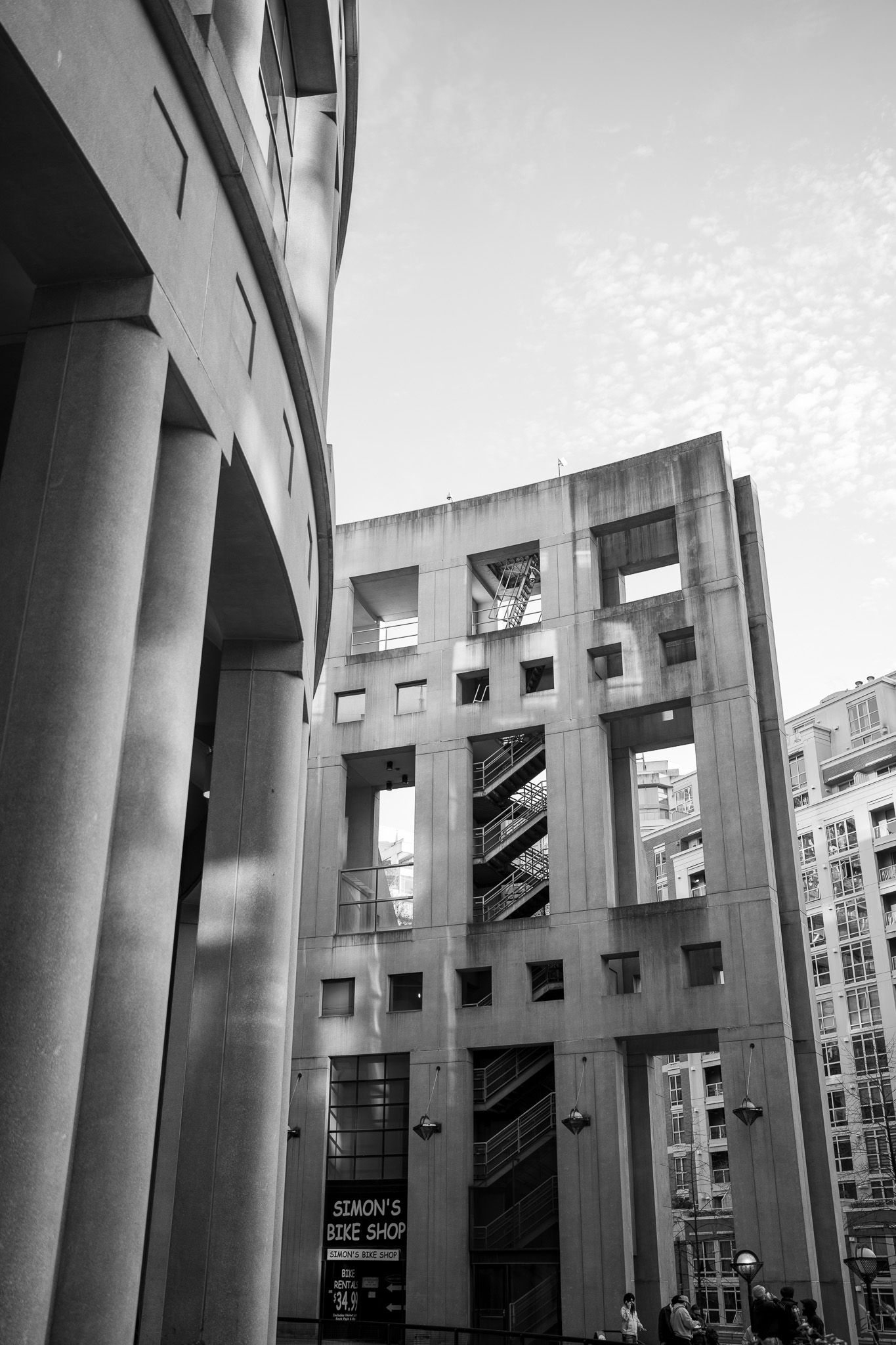 Modern architectural building with columns and geometric shapes photographed in black and white from different angles.