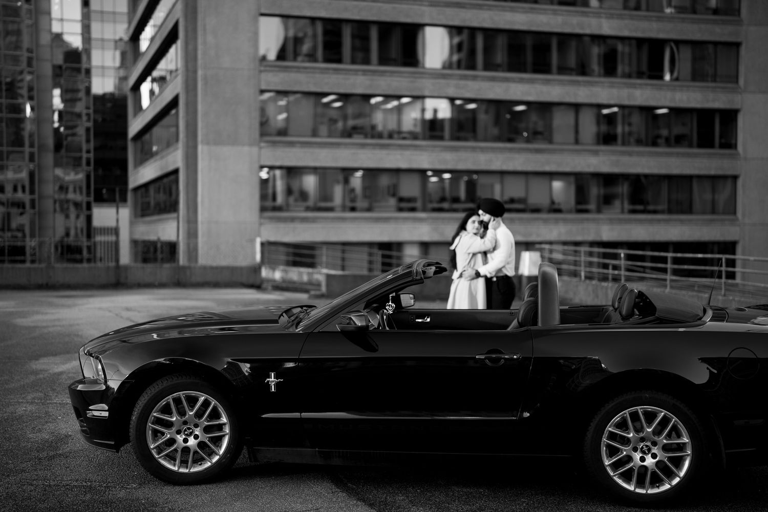 Black and white photo series showing a luxury convertible car parked in an urban setting at night.