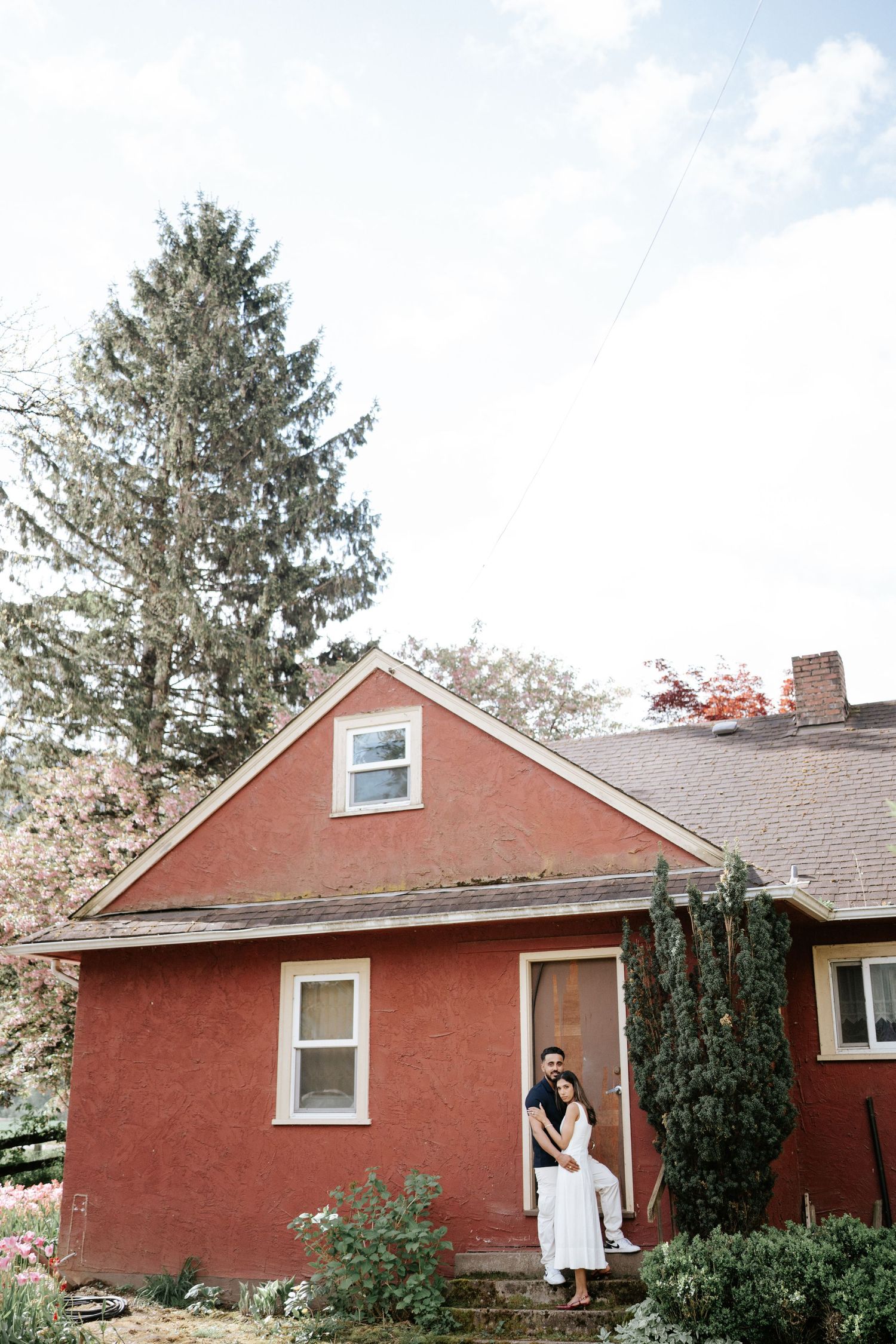 Red brick ranch house with white trim and evergreen trees shown from multiple exterior angles.