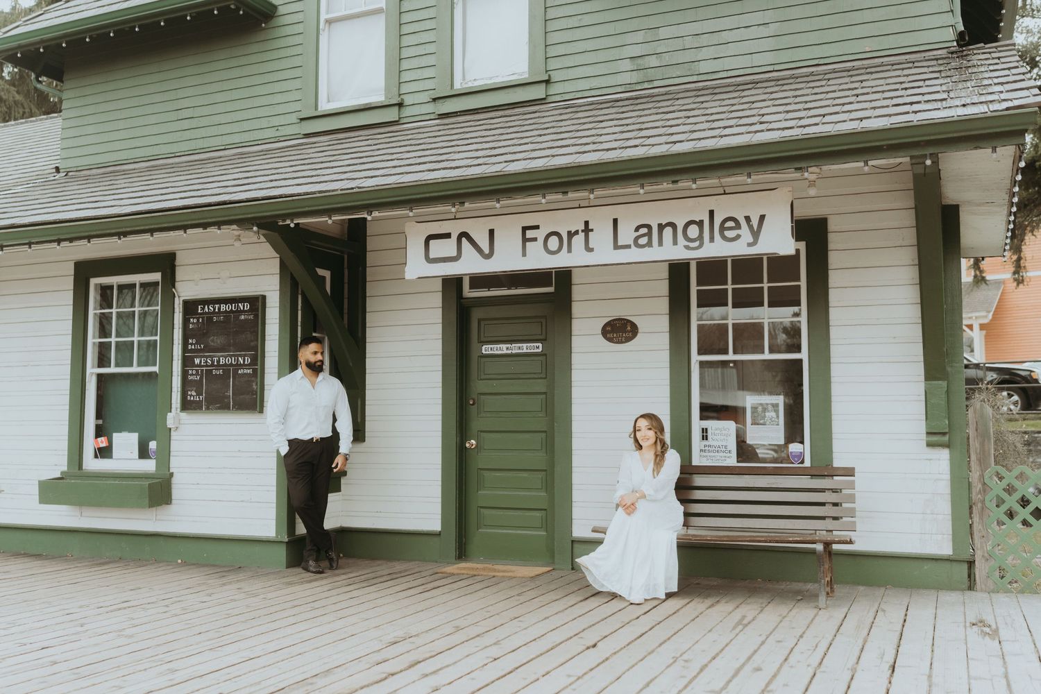 Green-sided historic building with wooden walkway and CN Fort Langley signage.