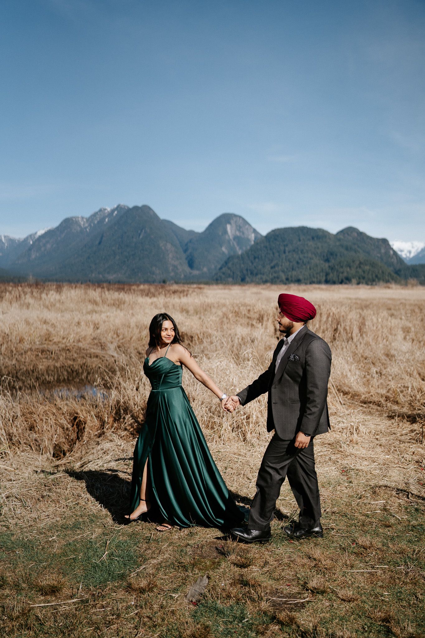A colorful photo sequence showing a couple playfully interacting in a field with mountain scenery behind them.