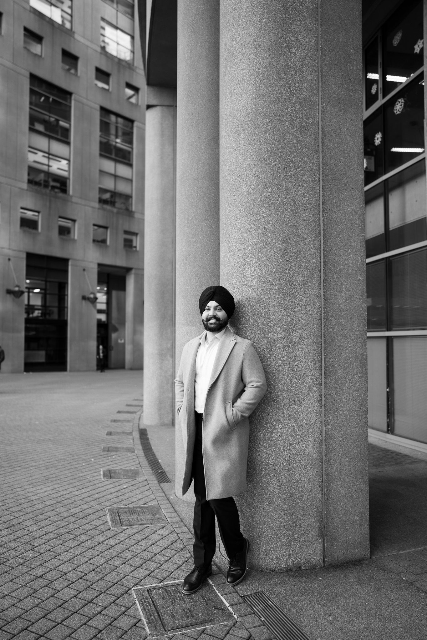 A black and white photo sequence shows a figure moving behind concrete columns in an urban architectural setting.