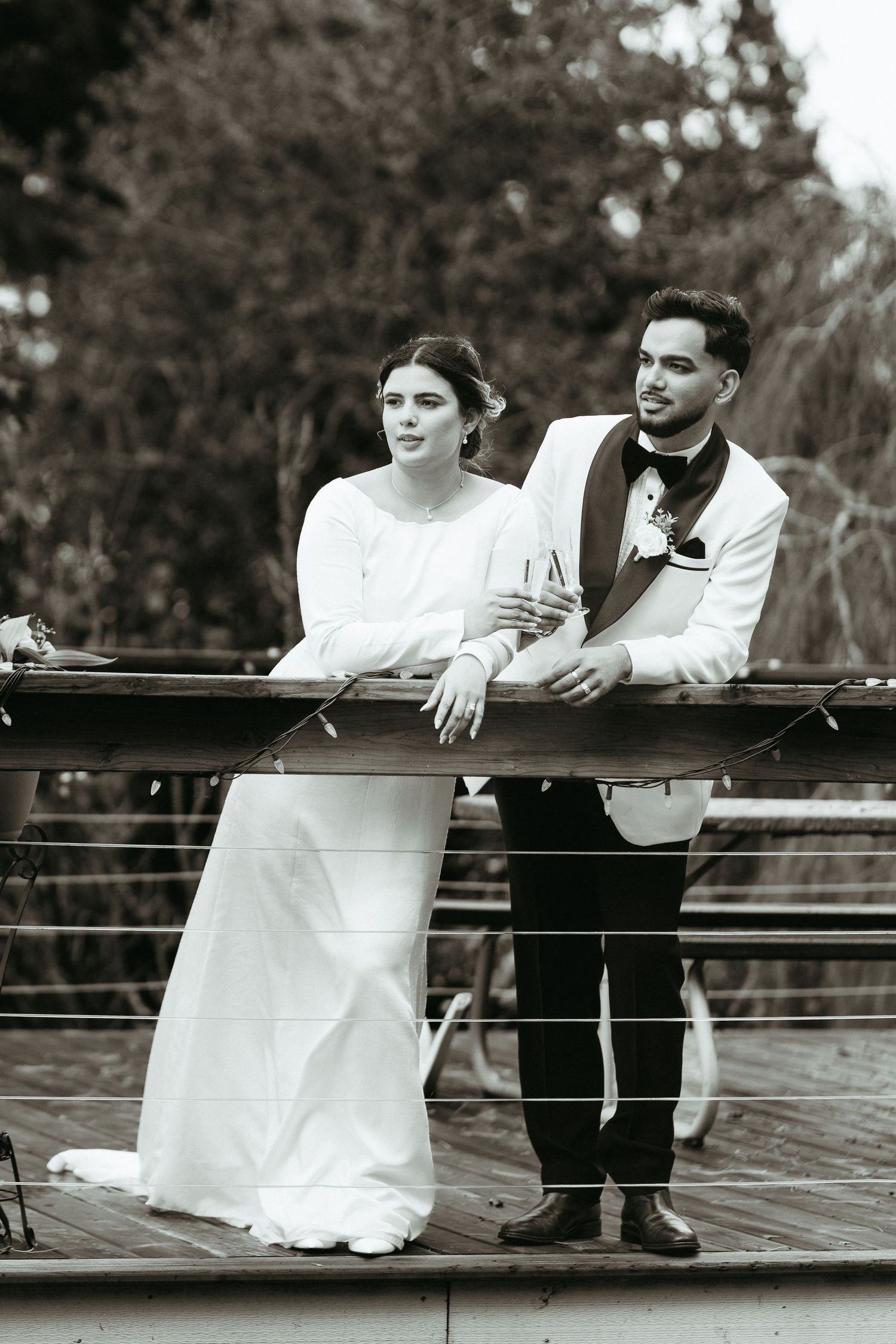 A romantic black and white sequence of a bride and groom leaning on a railing in three progressive shots.
