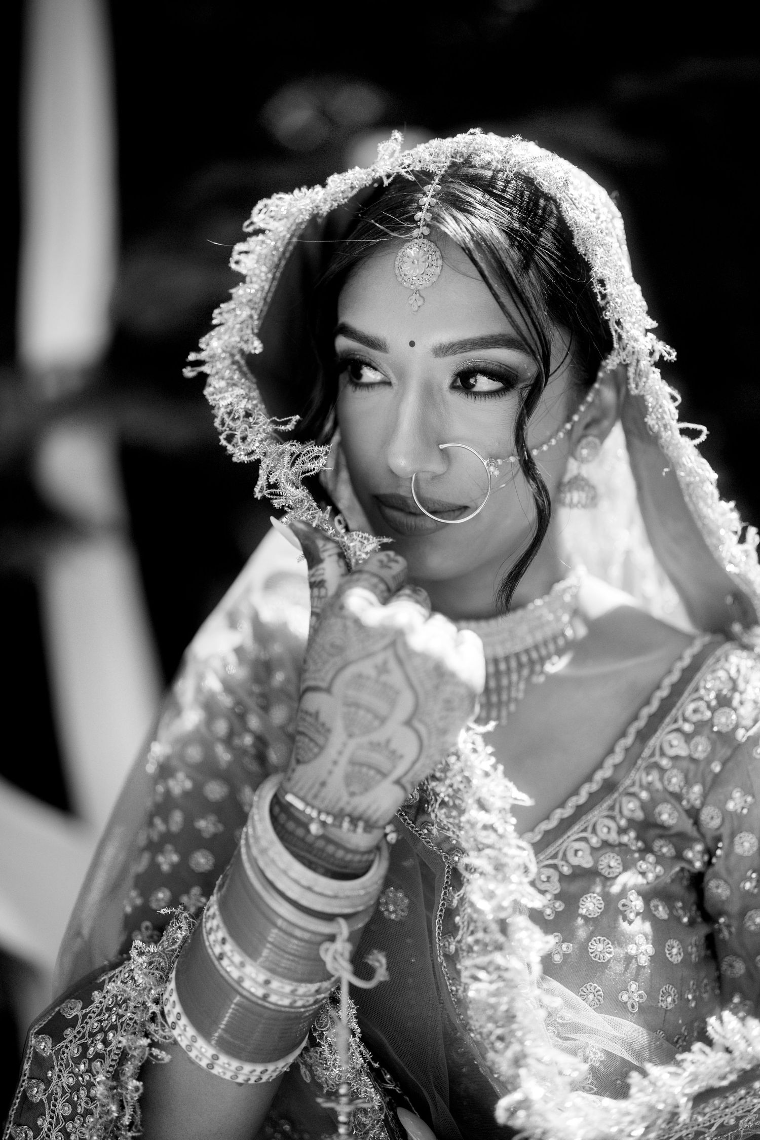 Black and white backlit bridal portraits with dramatic lighting and traditional jewelry.