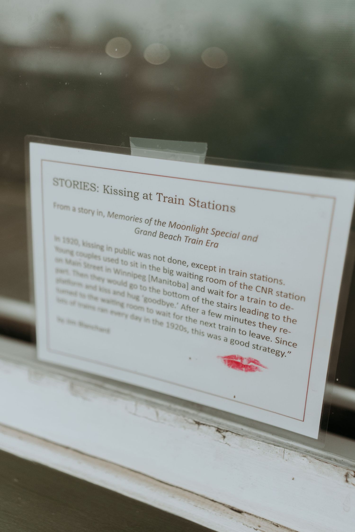 Vintage-style display cards with text about train station stories and memories.