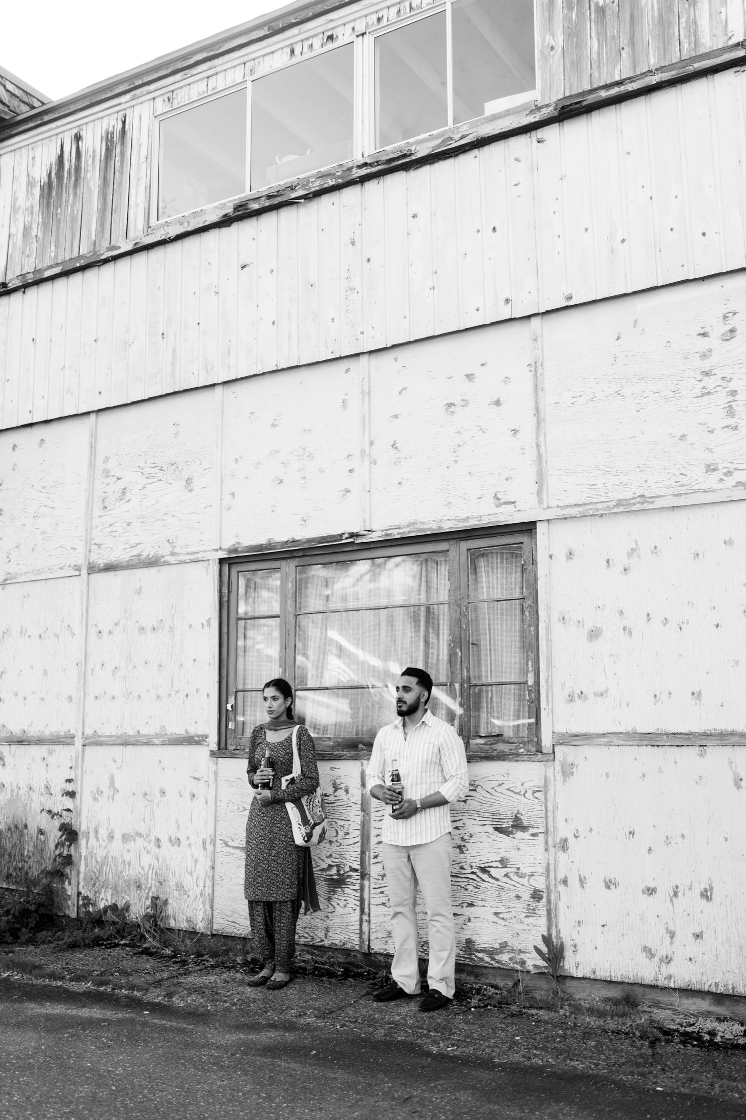 A sequence of black and white photos showing figures measuring and marking height marks on a white wall.