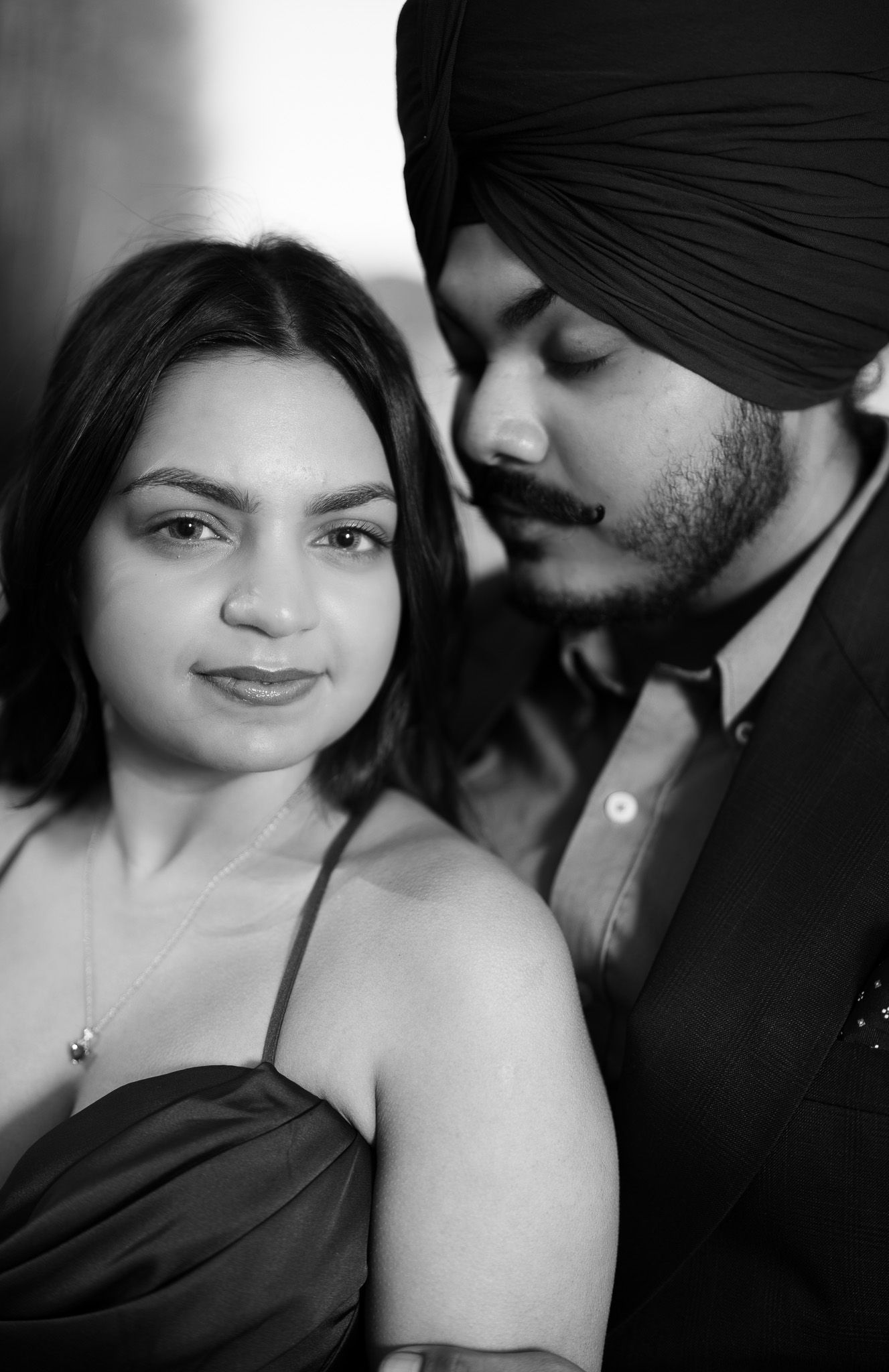 A romantic black and white photo series showing tender moments between a couple in four sequential frames.