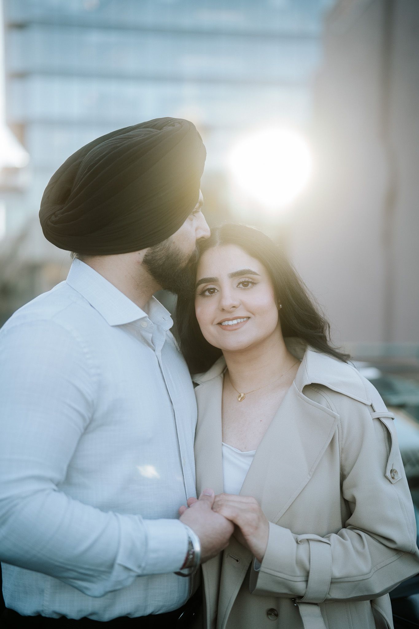 A romantic engagement photo series showing a couple in beige and white outfits with soft sunlit backlighting.