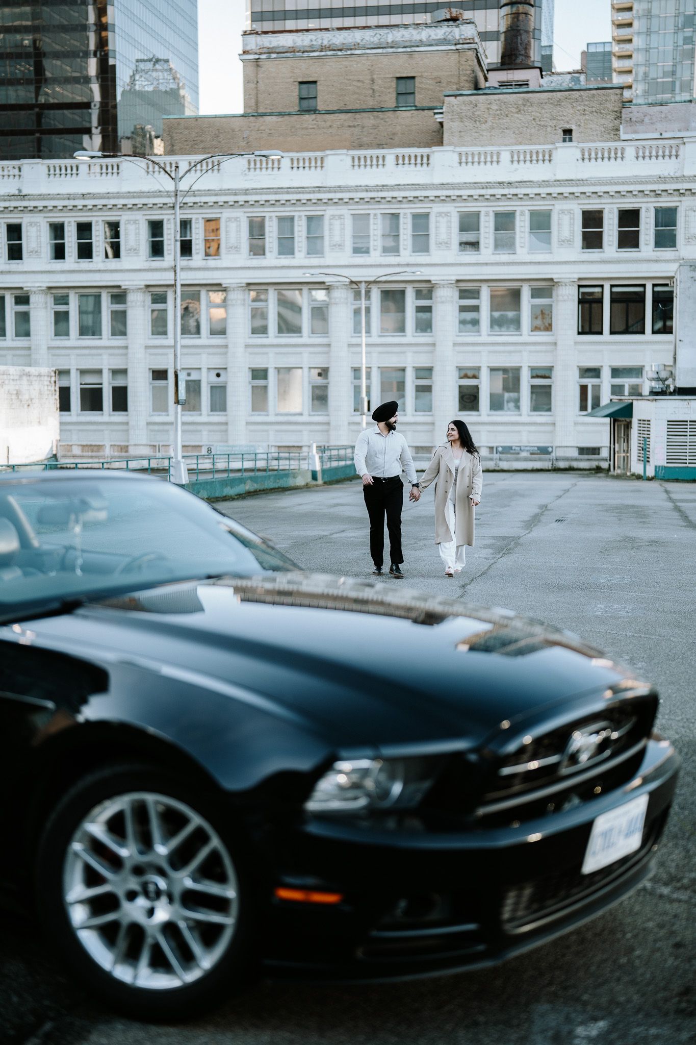 A black Ford Mustang sports car shown in a series of close-up detail shots against an urban rooftop setting.