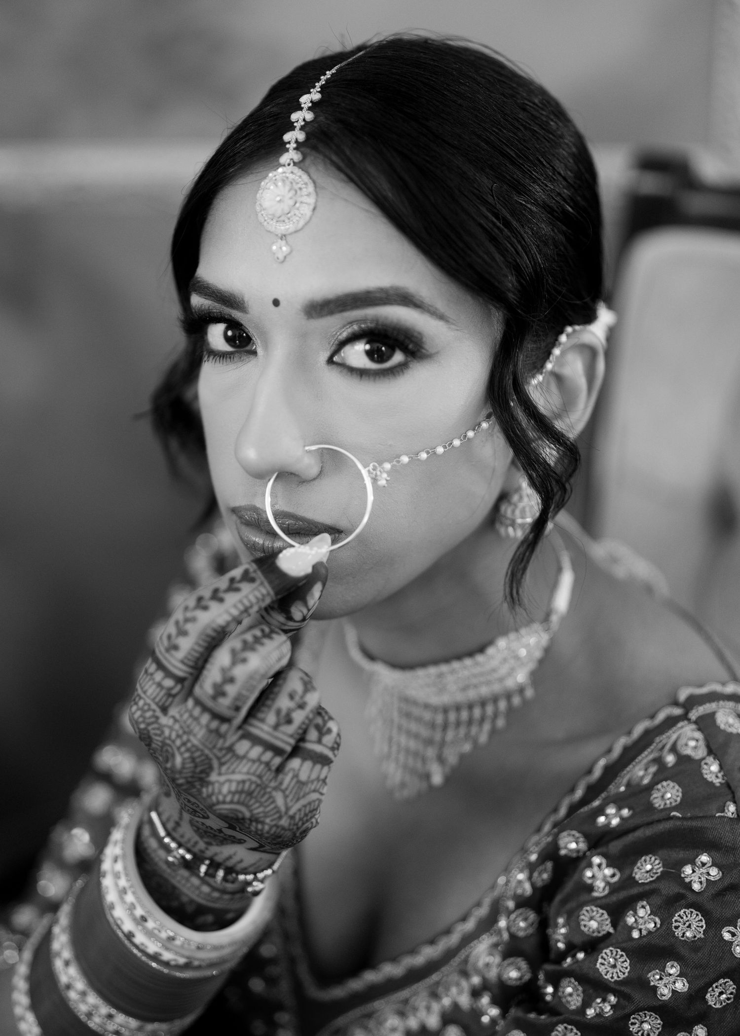 Black and white portrait series showing traditional Indian bridal jewelry and makeup details.