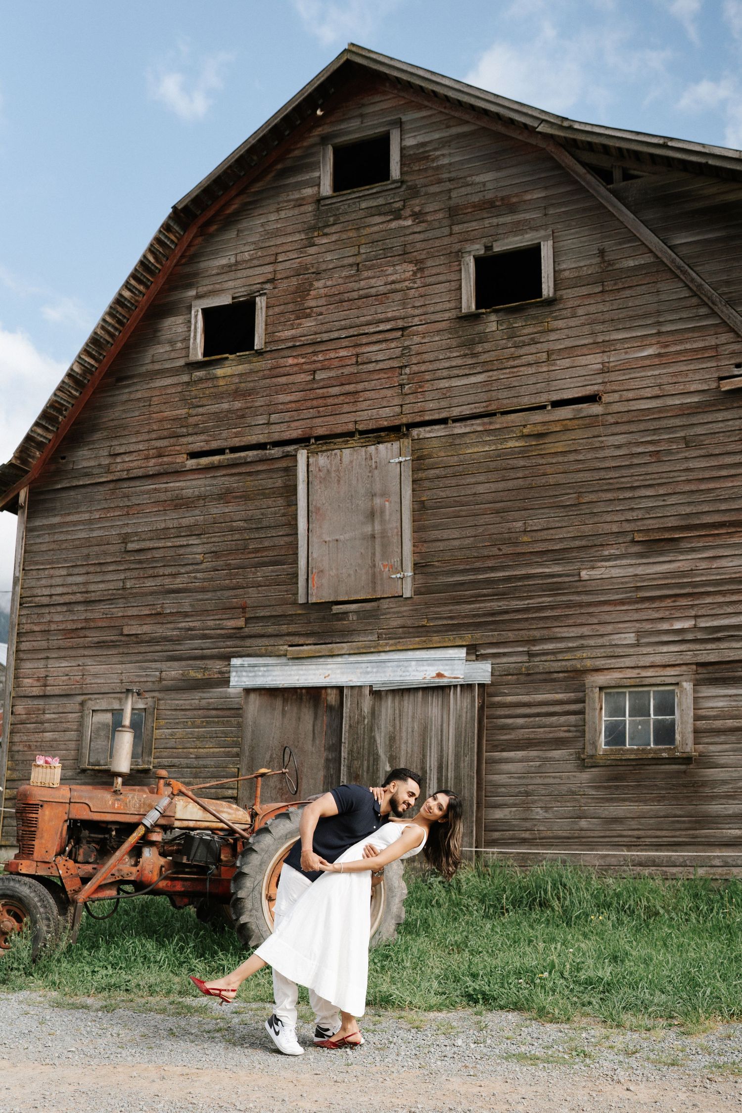 A sequence of five photos showing a figure in a white dress falling backwards near a rustic wooden barn.