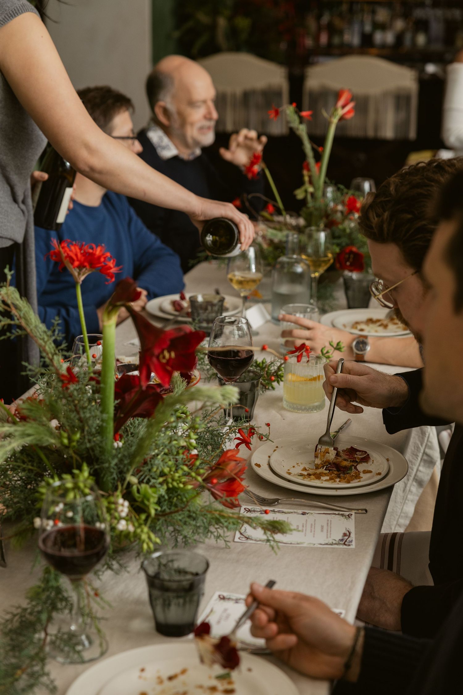 Dining table set for a holiday meal with festive centerpieces and place settings.