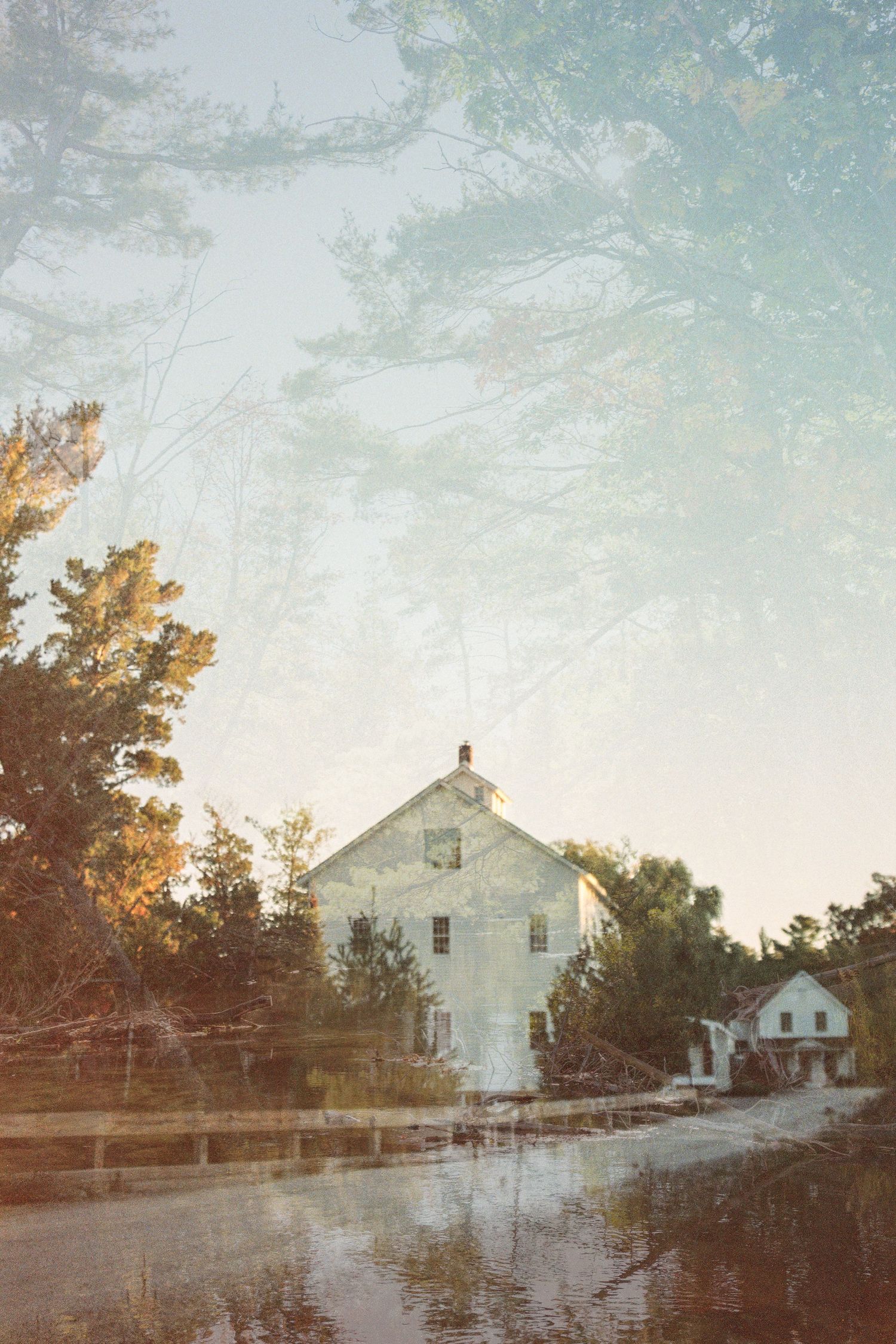 White buildings reflected in still waters during golden hour.