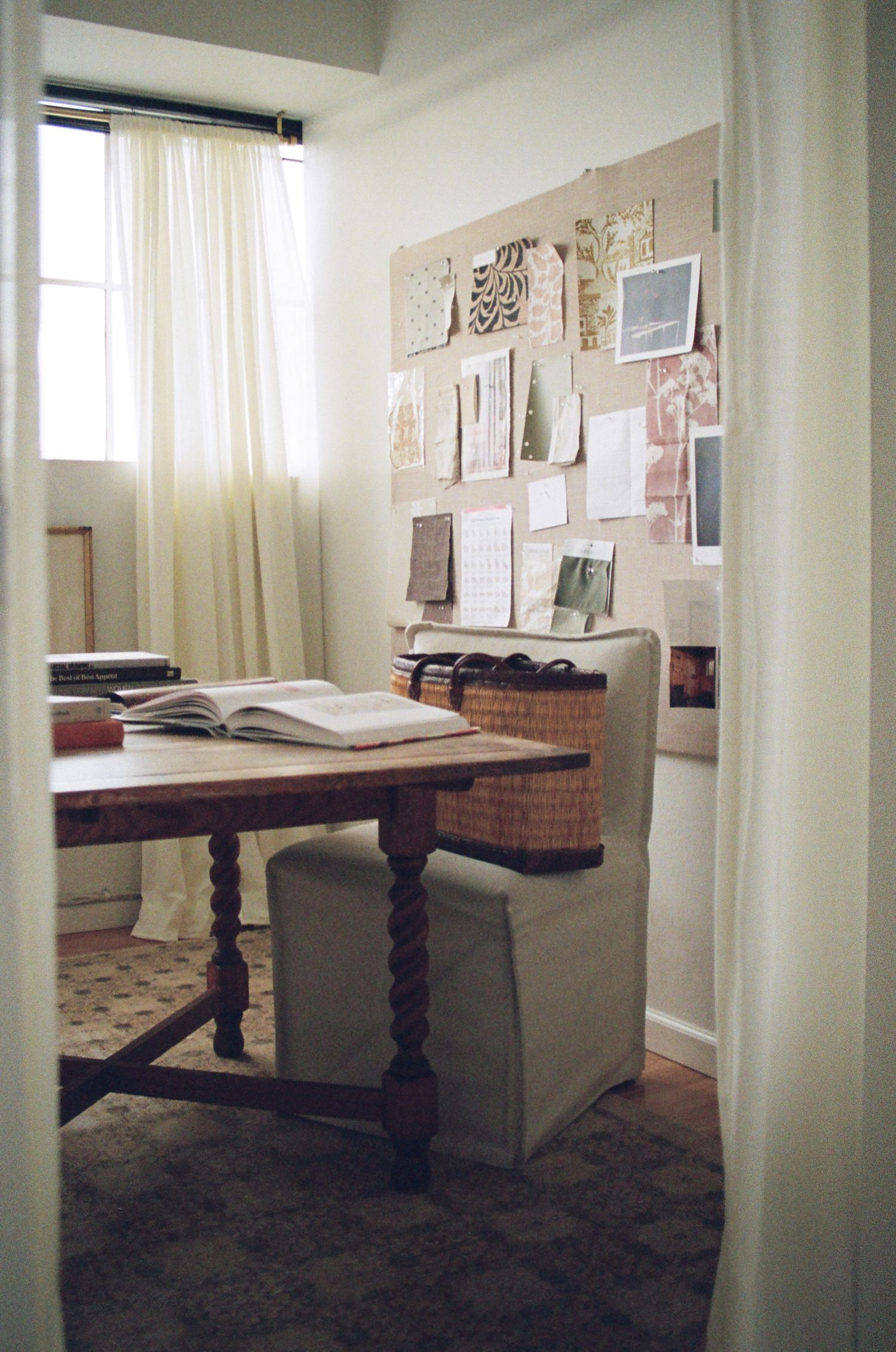 Study space with vintage wooden tables and benches displaying open books and wall-mounted documents.
