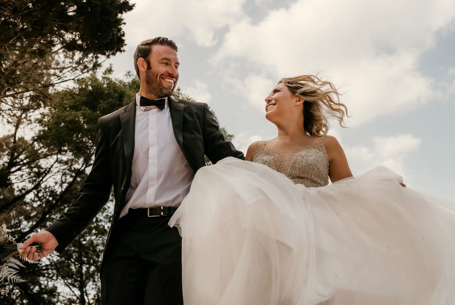 A playful sequence of wedding moments captured against a cloudy sky.