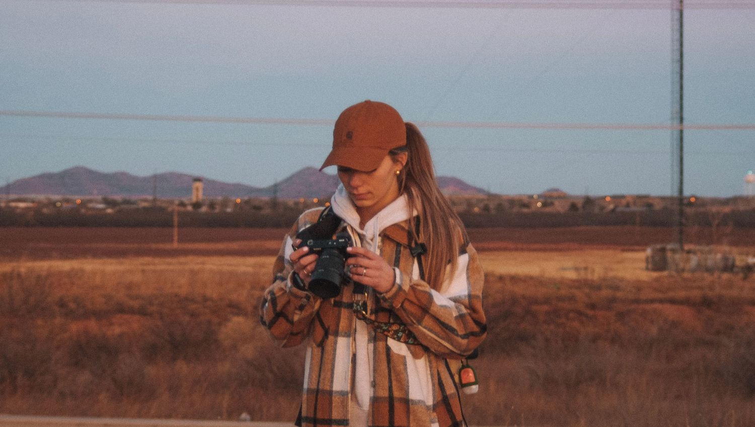 Photographers capturing desert landscape during golden hour.