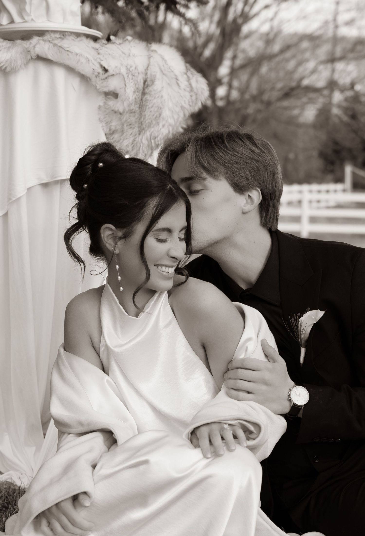 A romantic black and white photo series showing a couple embracing and sharing tender moments on a porch.